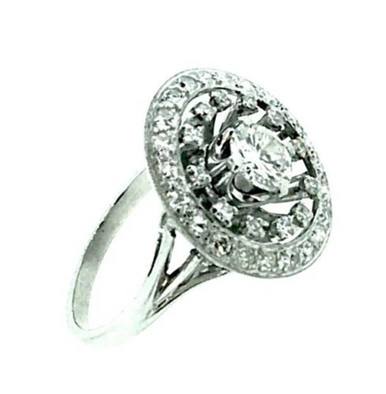 Ring features an Old European cut diamonds center weighing 0.84ct , I color-VS2 clarity, set in four prong setting. The diamond is surrounded by 12 floating old single cut diamonds and additional 22 single cut diamonds bordering the entire circle