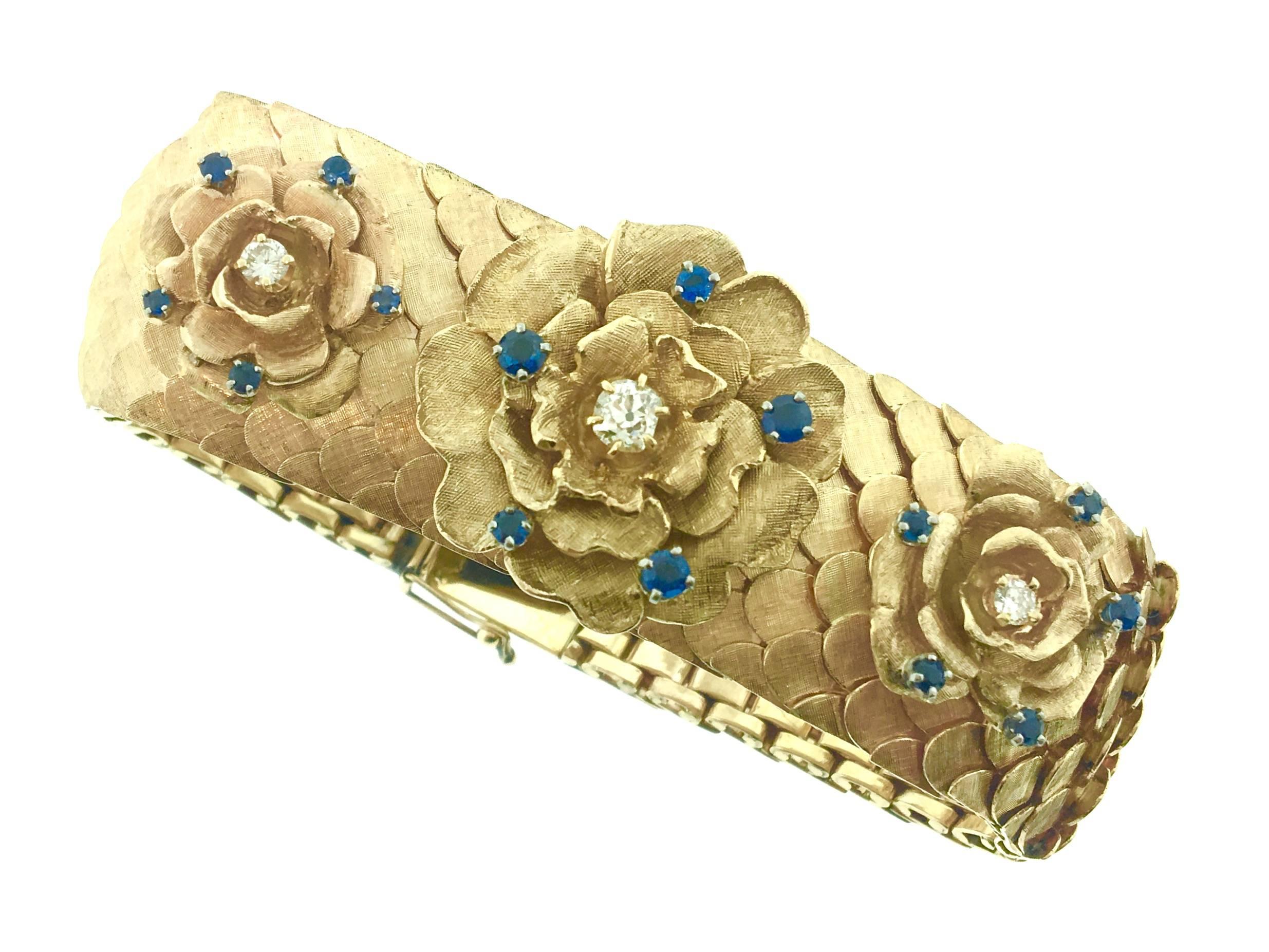 Flexible 1 inch wide Rose Gold Bracelet with textured scales and rose florets on the top. Each floret is studded with one diamond and 5 blue sapphires. Total diamond weight is estimated .50 carats. Total sapphire weight is estimated .85 carats.