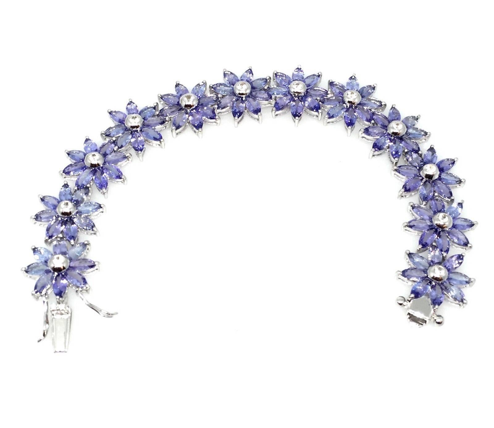 Statement Tanzanite & Diamond bracelet featuring marquise shaped Tanzanite, with beautiful light purple color, nicely calibrated  and lively, weighing a total of 30.60 cts.  There are also 0.91 ct of round brilliant cut diamond, SI