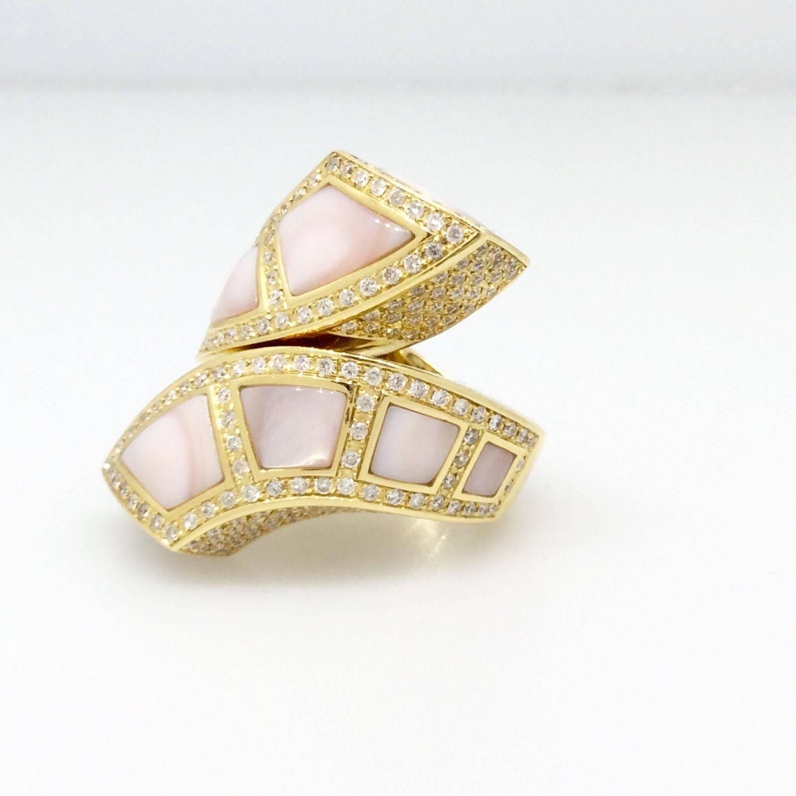 Gorgeous designer wrap ring in 18k yellow gold by Victoria Casal, containing 10 inlaid sections of pink mother of pearls, and 2.29 cts of round brilliants, pave set on all sides. Diamond quality SI1 clarity and H-I color.  Ring size: 7.25.
Marks: