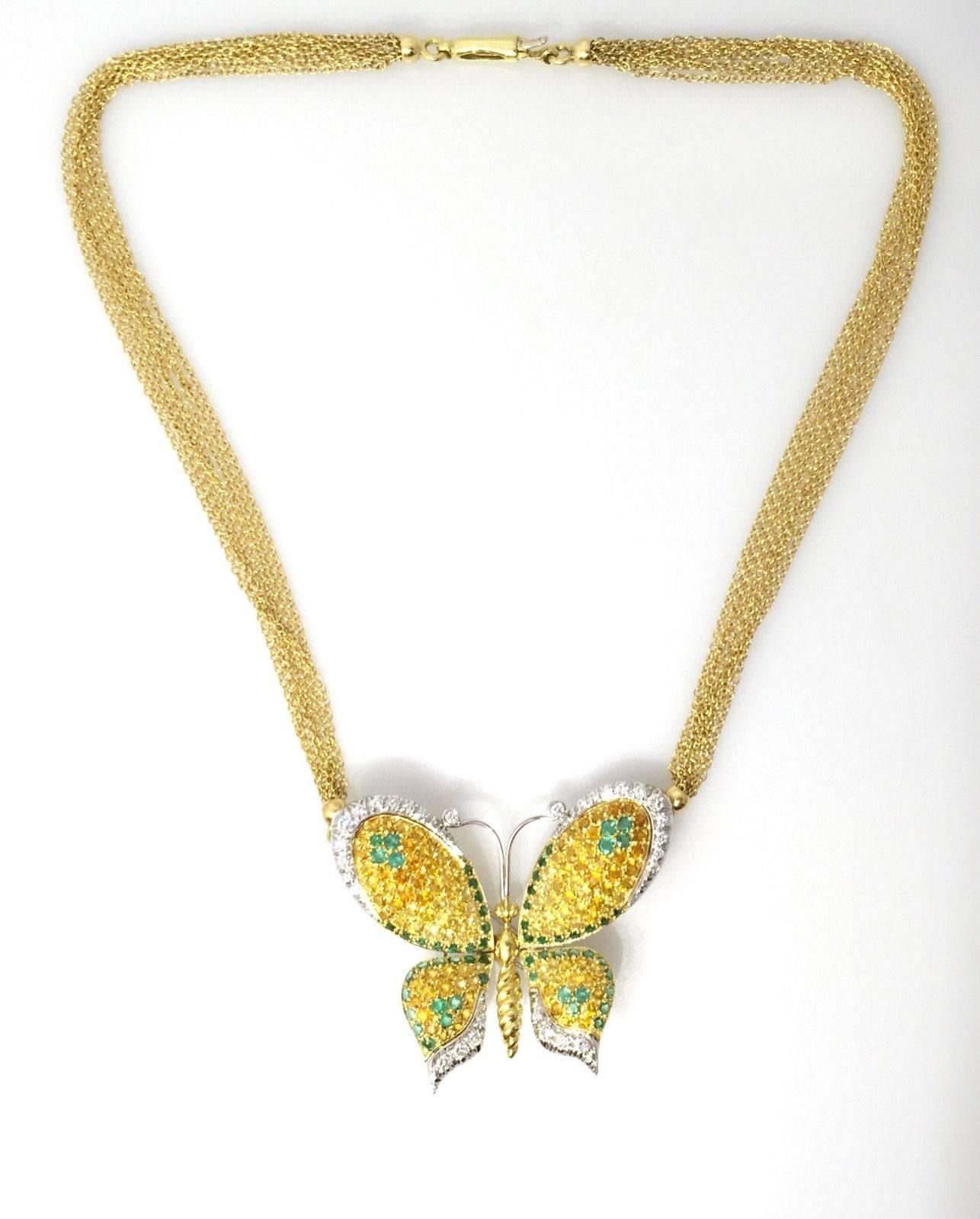 Chimento butterfly pendant encrusted with yellow Sapphire, Emerald and diamonds in 18k yellow & white gold.  The butterfly's wings are set primarily with approx 3.80 cts of yellow Sapphires, approx 1.40 ct of Emeralds, and approx 1 ct of round