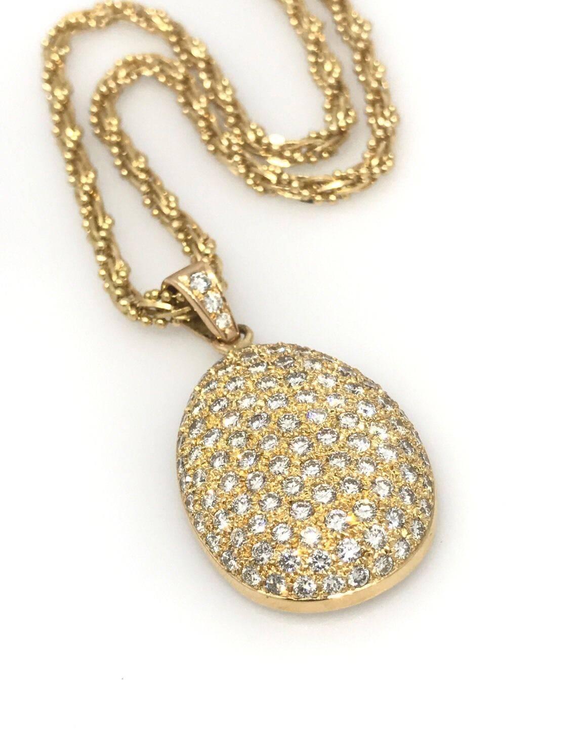 Pave diamond teardrop pendant in 18k yellow gold hanging from fancy beaded/link twist chain.  There are 3.78 cts in round brilliant diamonds, VS clarity, G-H color. Diamond Bale. Chain measures 16.5 in long.
Both pieces weigh 50 grams. Marks: 750,