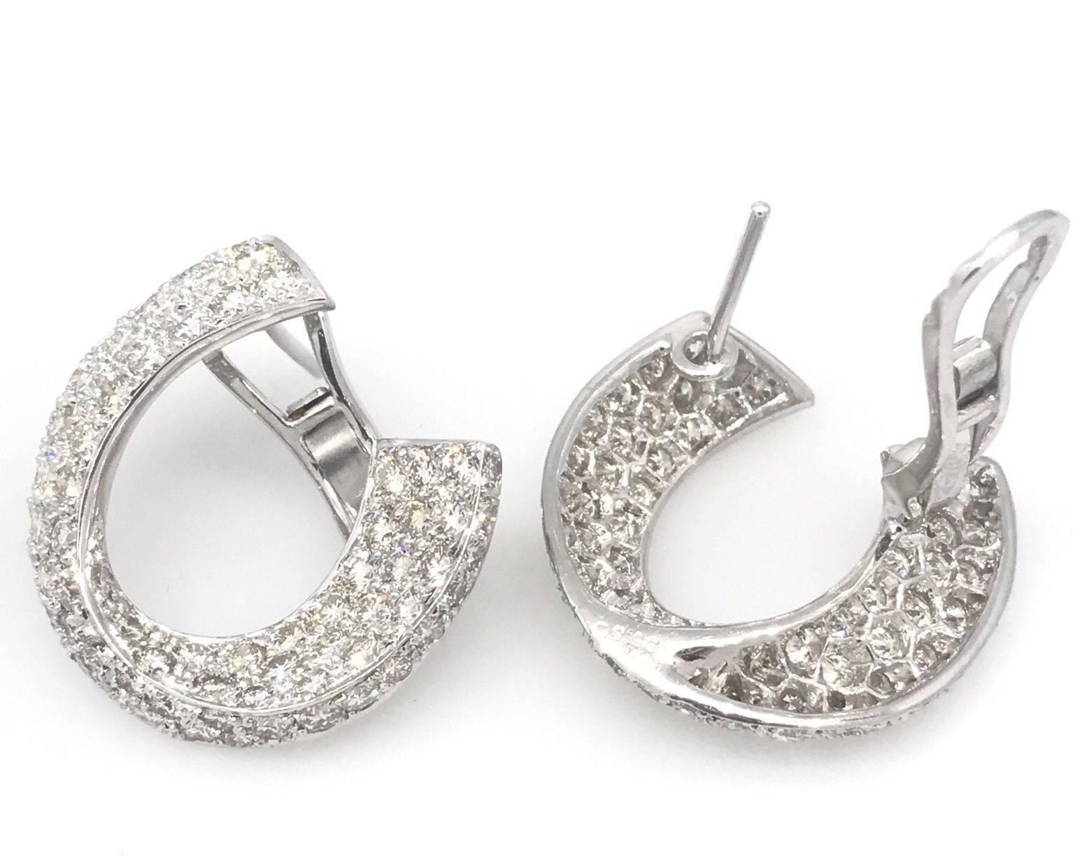 Pave-set diamond earrings in shape of crescent in 18K white gold containing 5.50 carats of round brilliant cut diamonds with color of H and clarity VS. Earrings weigh 13.7 grams. Marks: K18WG, D5.50.