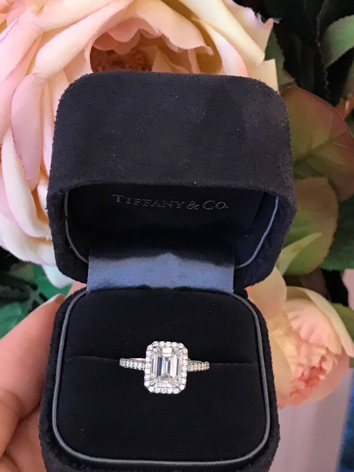 Tiffany & Co. "Soleste" diamond ring with Emerald cut diamond in the center weighing 1.64 carat, certified G color and VS1 Clarity. Made in Platinum 
Hallmark : TIFFANY & CO PT950  32916724 D1.64.
Ring weighs 3.7 grams. Ring is a