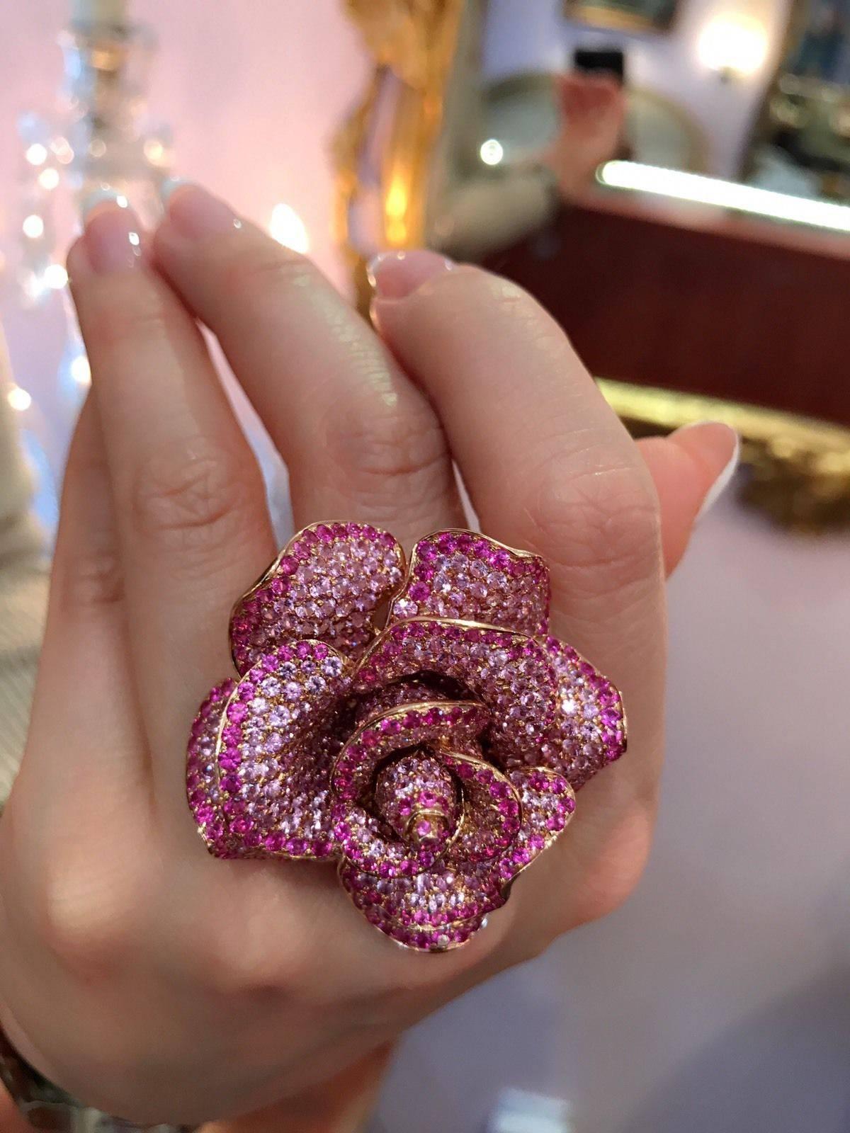 Pink Rose cocktail ring by ADLER containing over 20 carats of pave set round brilliant cut Pink Sapphires. The beautiful light pink Sapphire encrusted in every petals outlined with contrasting deep pink Sapphire on the edges.l There are also 0.90