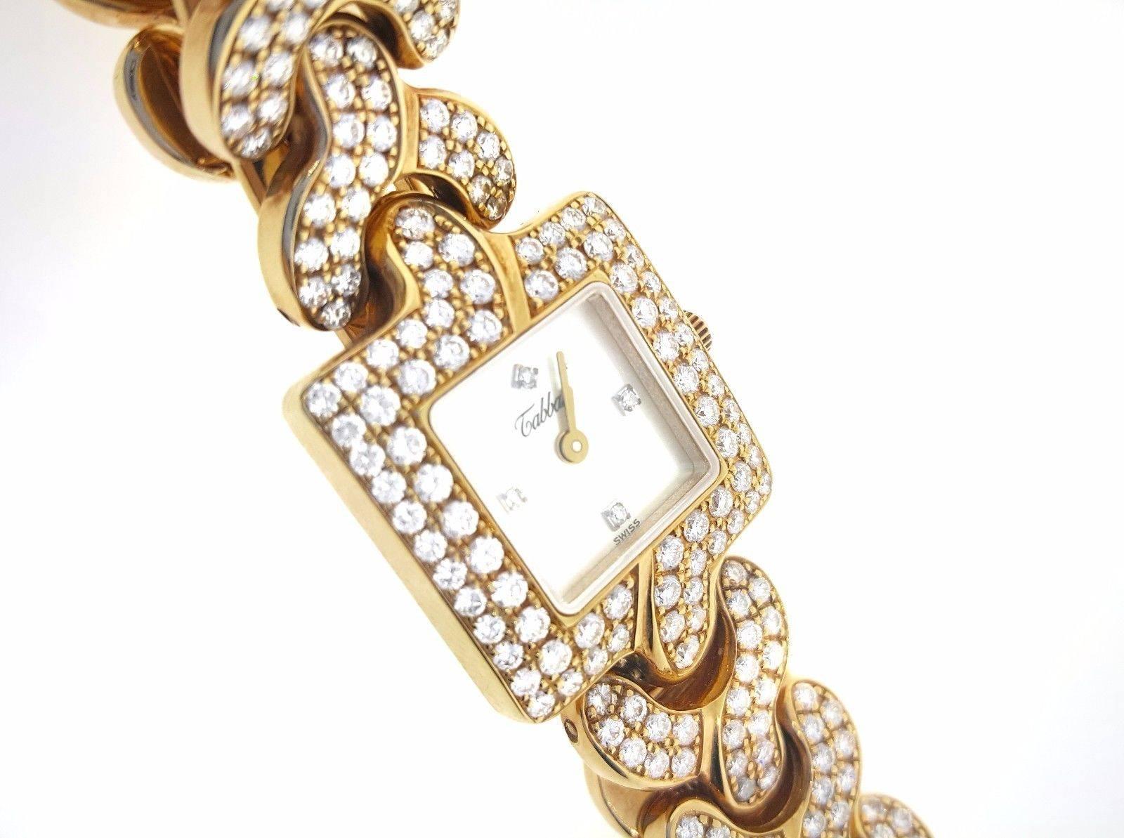 Ladies diamond dress watch with square mother of Pearl face in 18k yellow gold by Tabbah, featuring square dial made of mother of pearl with 4 diamond markers.  Watch has a wide pave diamond bezel and diamond link band. 
 Diamonds are on all but 6