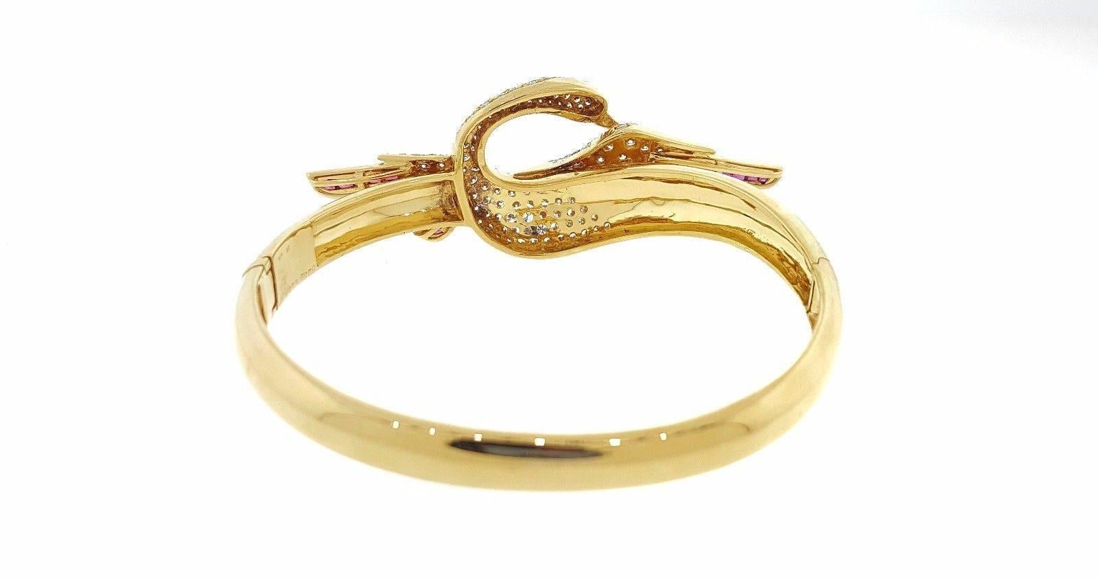 18k Oval Bangle Bracelet with Ruby and Diamond Swan with outstretched wings.The piece has 2.02 carats of Round Brilliant Diamonds, with the pave set in the body of bird. The diamonds are clean and white. The clarity is VS2-SI1 and the color is H-I.