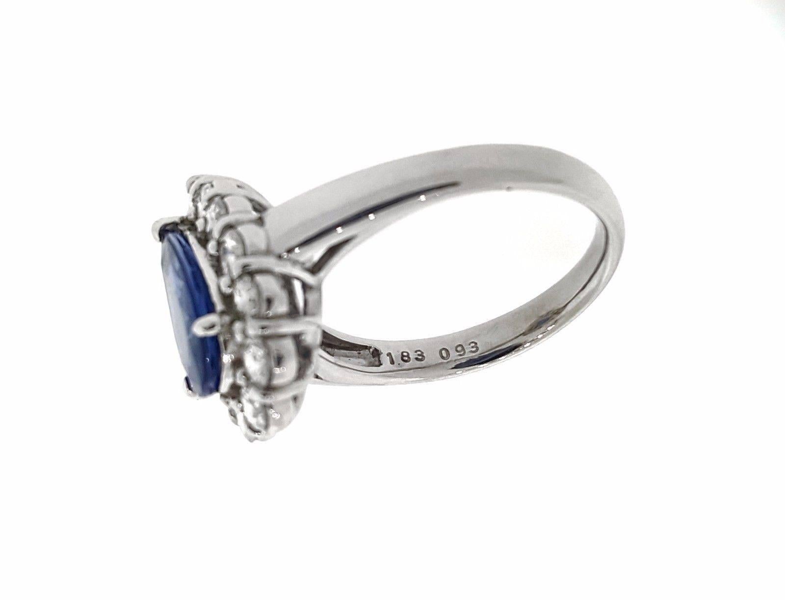 Pear-shaped cornflower blue sapphire with diamond halo set in platinum. Sapphire weighs 1.83 carats. The diamonds weigh .93 carats in total. The clarity is VS2, and the color is H. The setting is platinum. It is marked with Pt900, 1.83, 093. The