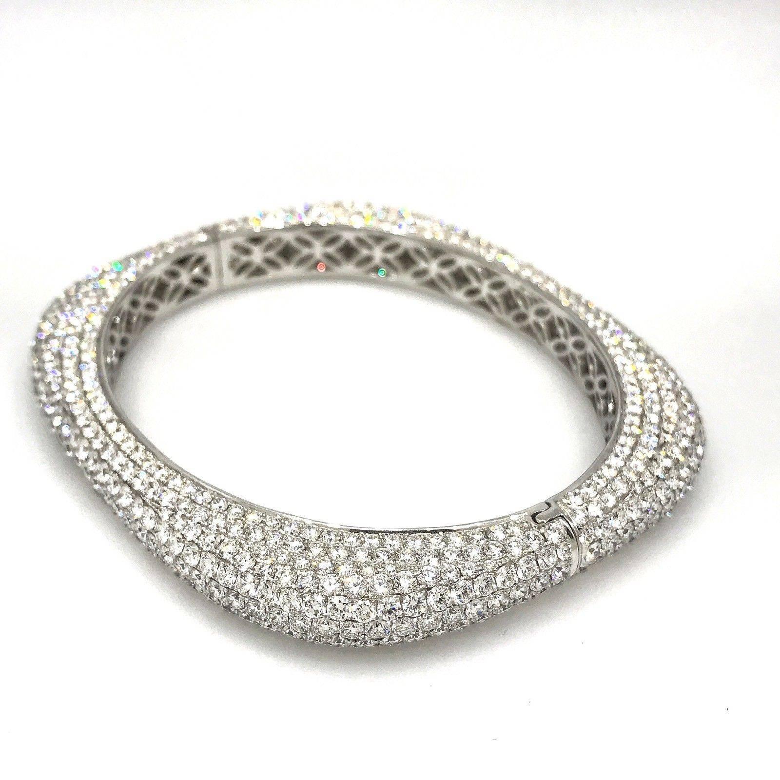 Very high quality diamond pave bangle bracelet with rounded square shape with oval opening, featuring 22.59 carats of round brilliant full cut diamonds, pave set over entire bangle. Diamond quality is VS clarity and G color. Excellent craftsmanship.
