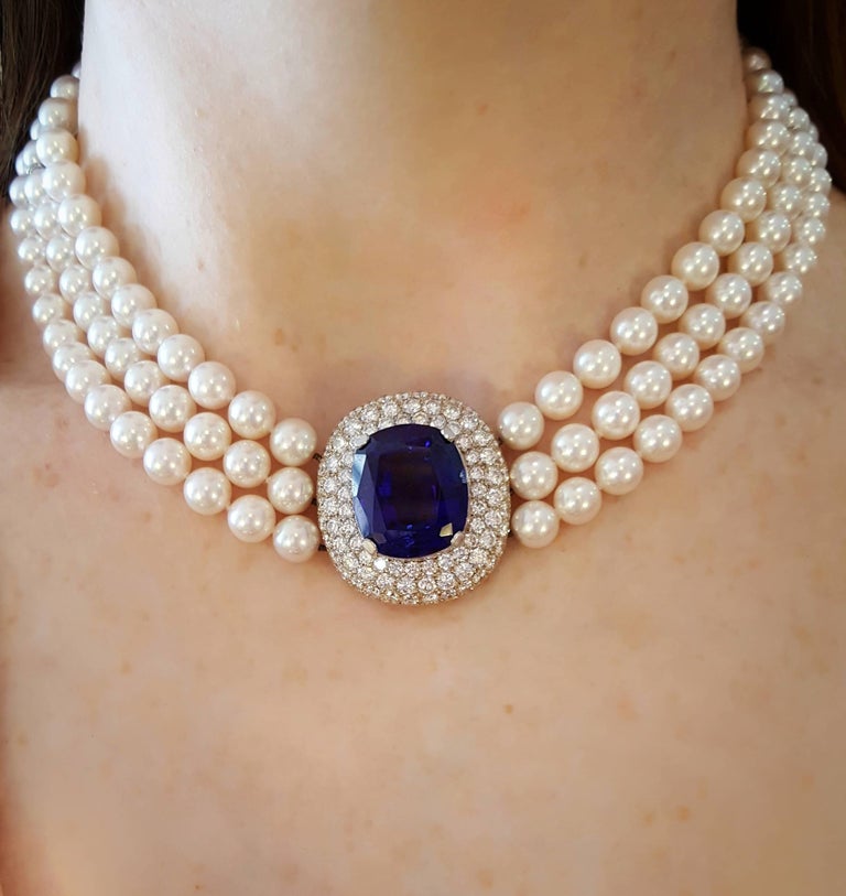 A magnificent Mikimoto Necklace featuring a cushion shaped Tanzanite center piece weighing 34.75 carats, surrounded by pave set round brilliant cut diamonds, on a triple row of Akoya pearls.  Top quality Tanzanite display deep blue-violet tone,