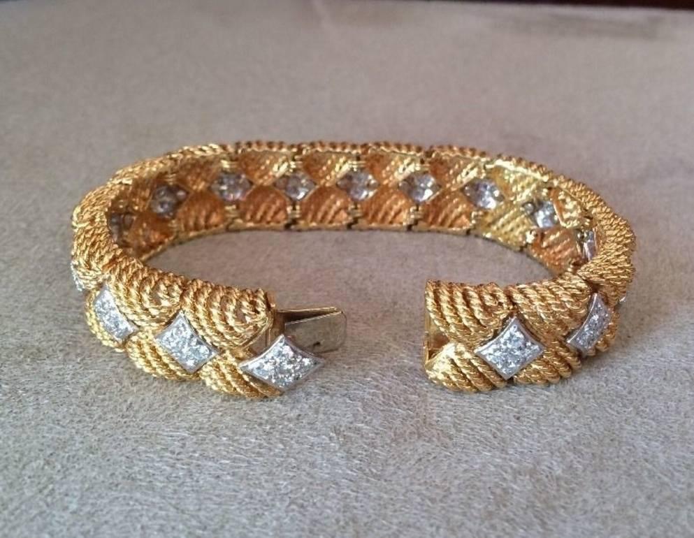 Vintage mid-century RUSER Diamond Bracelet, consists of heavy textured links of 18k Yellow Gold with marquise-shaped diamond plaques in the center of each link.
 
80 Round Brilliant Cut Diamonds, totaling 5.00 ctw estimated
VS clarity, F color