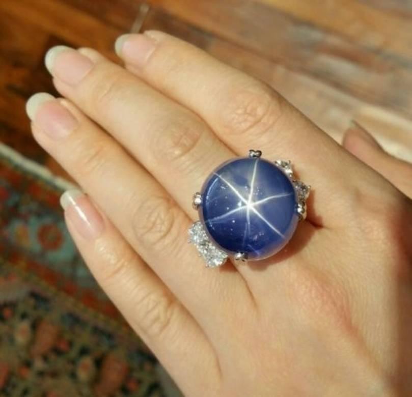 GIA Certified NATURAL, UNHEATED 101.55 carat Ceylon Star Sapphire with Heart shape diamonds setting in Platinum.

Oval Shaped Double Cabochon Cut Blue Star Sapphire with Translucent Blue color and shows very sharp 6-ray star/asterism

Side