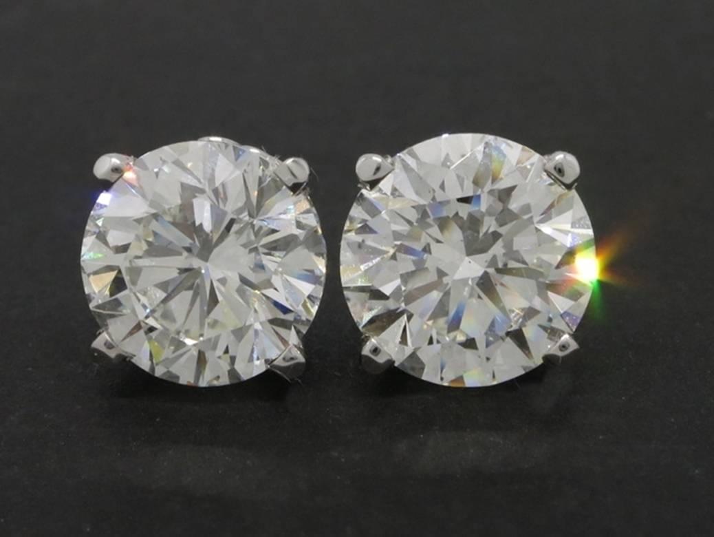 GIA Certified Matching Pair Round Brilliant Cut Diamond Stud Earrings.

(1)  4.03 ct -- K color, VS1 clarity
Measurements: 9.87 - 9.91 x 6.39 mm
Polish/Symmetry:Good/Good
Fluorescence: None 

(1) 4.06 ct -- J color, SI1 clarity
Measurements:
