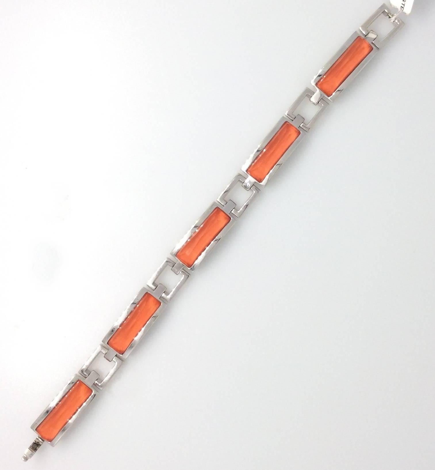 From Stephen Webster's Crystal Haze collection, 18k White Gold links with center sections of Coral and Faceted Quartz. Bracelet measures 7.25 inches in length and .4 inch in width. Weight is 55.1 grams. The back of each link is carved with Stephen