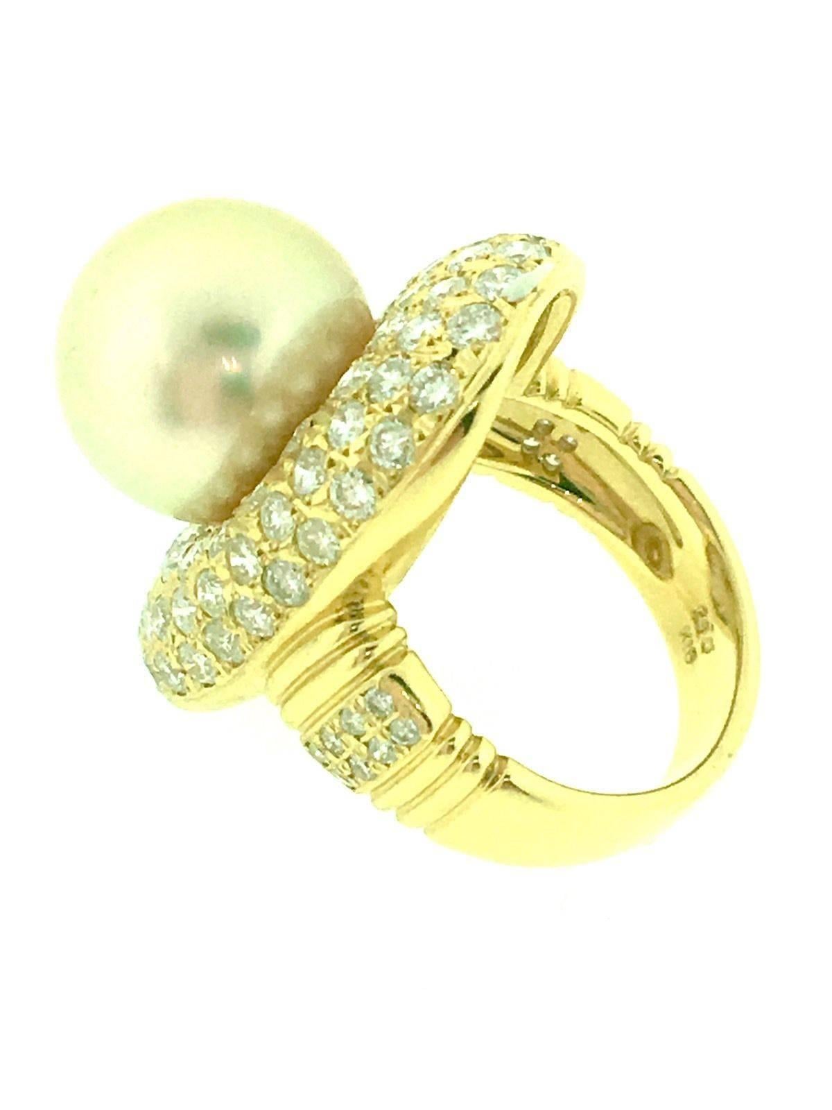 Elegant Pearl and Diamond Cocktail ring featuring 12.5mm Golden South Sea Pearl in the center framed by 2.60 carats of Round Brilliant White Diamonds
G color and VS clarity, set in 18k yellow gold. Ring shank beautifully decorated with 8 white