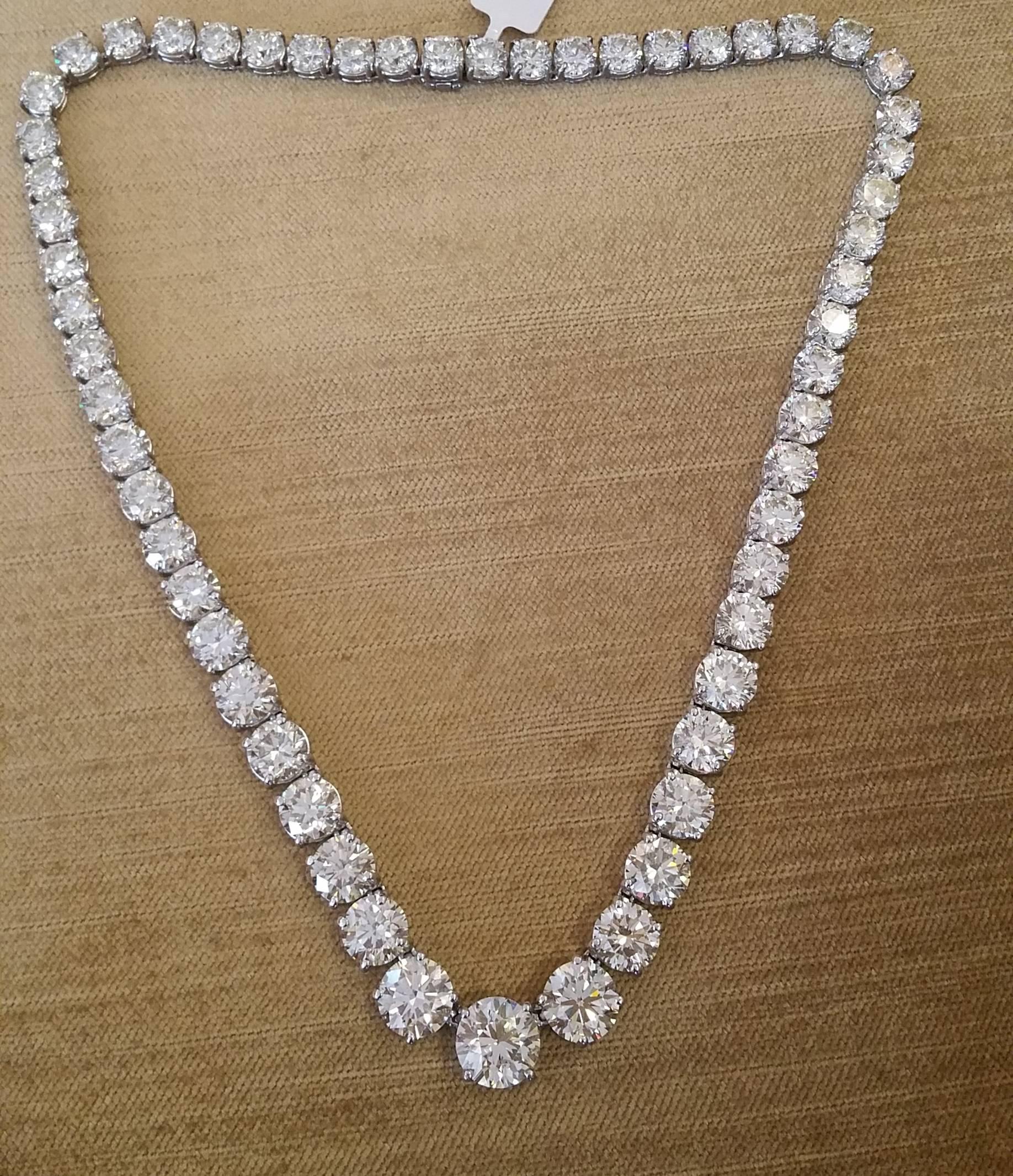 Diamond riviere necklace features 57 round brilliant cut diamonds with center diamond weighing 4.14 carats.  Diamonds are individually prong set in a graduated style. Diamond total weight is 83.75 carats. 
Diamond quality is graded as estimated O-P