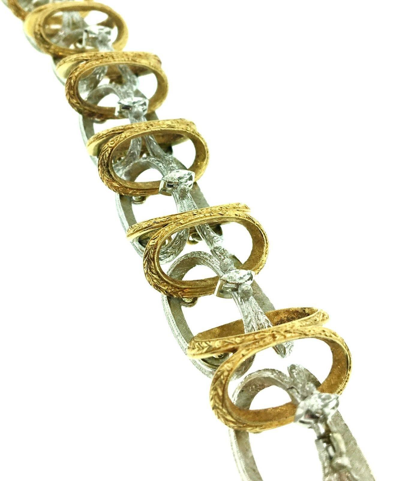 A Textured 18k Yellow and White Gold Link Bracelet with Marquise Diamonds by Italian Designer Loris Abate. The bracelet is beautifully constructed with open links in alternating white and yellow textured gold. Each connector holds a single Marquise