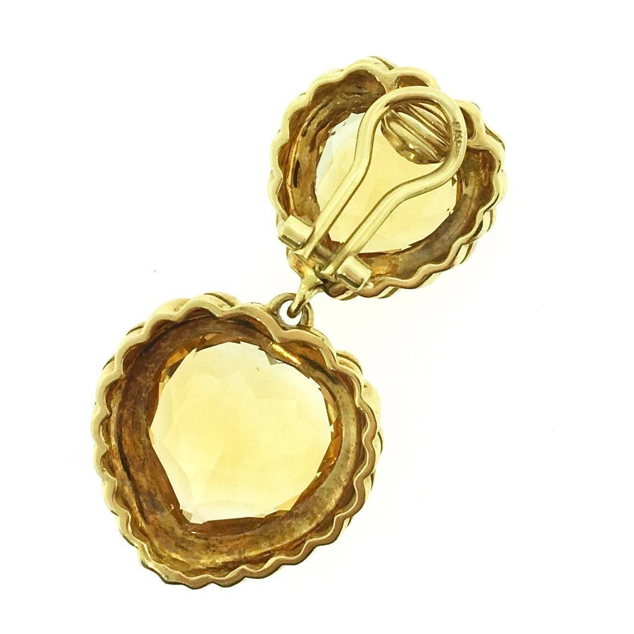 Large Heart Citrine Dangle Earrings by Fred. Earrings feature four large Heart-shaped Citrines bezel set, one over the other, with high polish twist edging in 18k Yellow Gold. Top Citrines weigh approximately 7.00 ct each, bottom Citrines weigh
