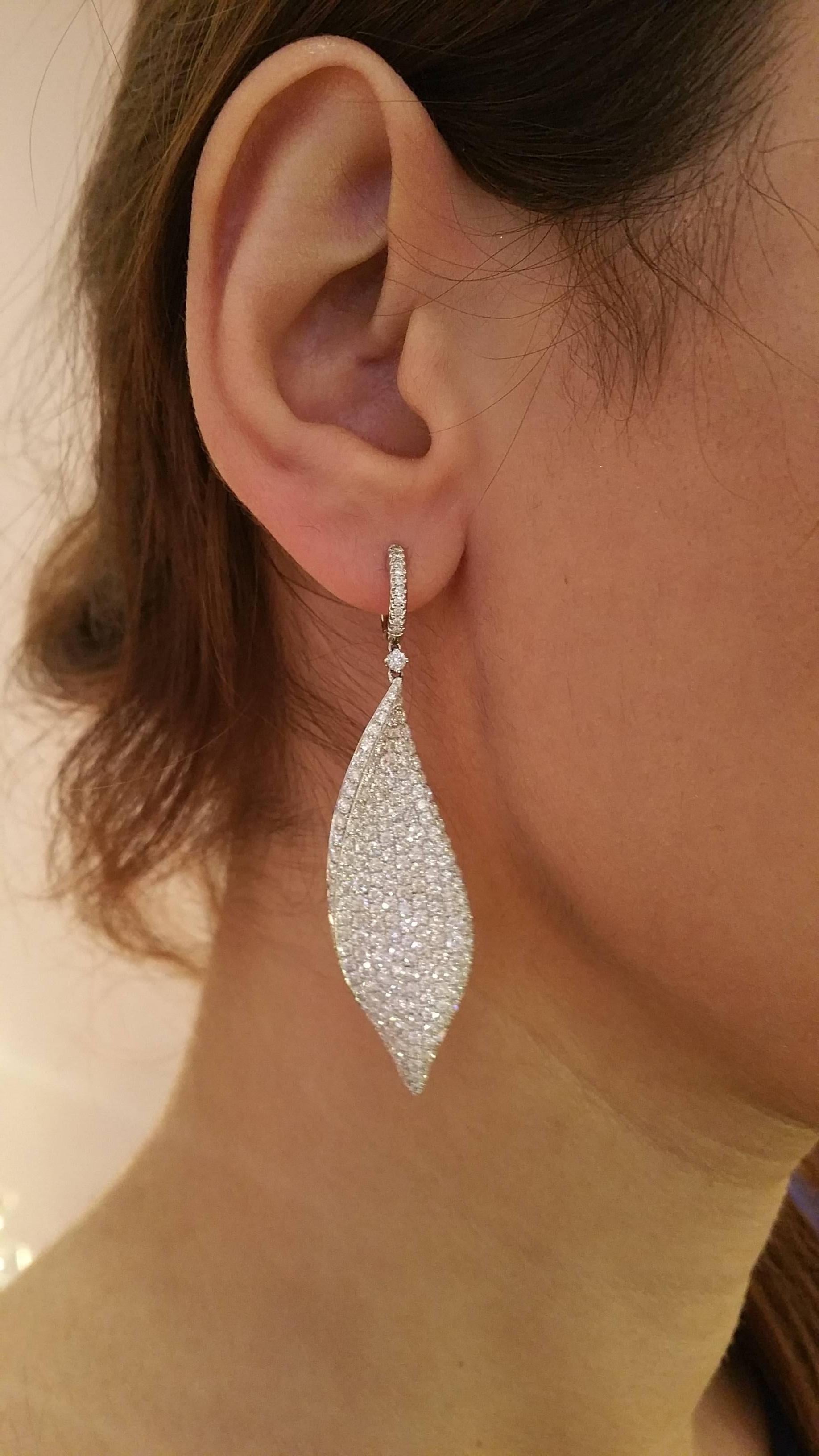 Elegantly draped diamond pave leaf earring in 18k white gold featuring 8.71 cts of round brilliant cut diamonds, pave set.  Diamond quality is approx H in color and VS2-SI1 in clarity. Set in high polished 18K white gold. Hallmarked 18K. 