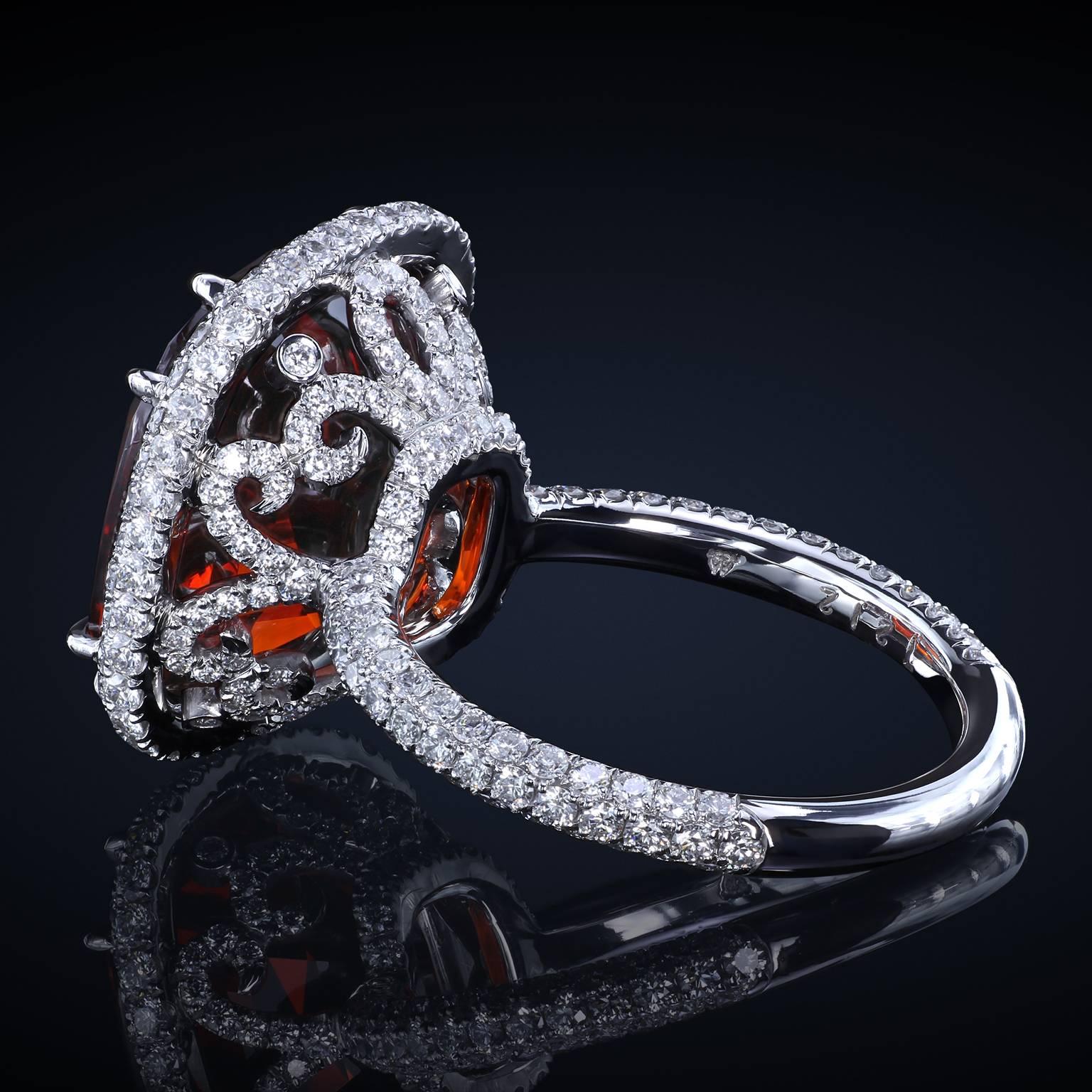 Bohemian sangria-colored garnet statement ring in a multi-row diamond pave halo. The design continues with intricate micro pave details encrusting the basket and the shank.

13.63 ct Garnet
1.82 cttw Diamonds

Ring size: 5.75