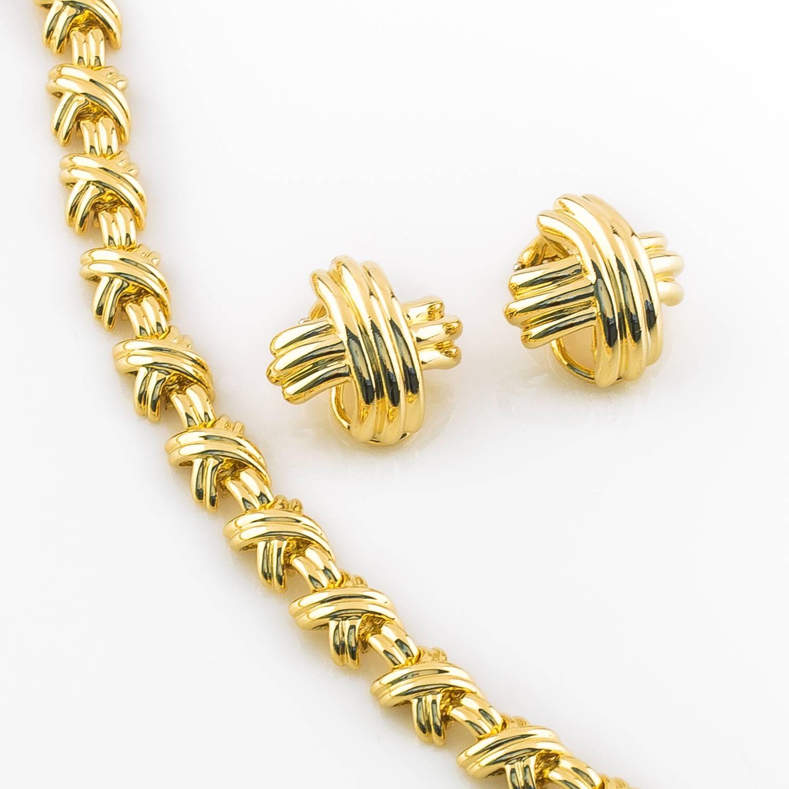 Paloma Picasso’s Signature X necklace and earrings from the Signature Collection. The bold x design is 18k yellow gold featuring polished surfaces and contemporary lines. Earrings are clip-on. Sold as a set.

Necklace 16in L (15.24 cm) Earrings