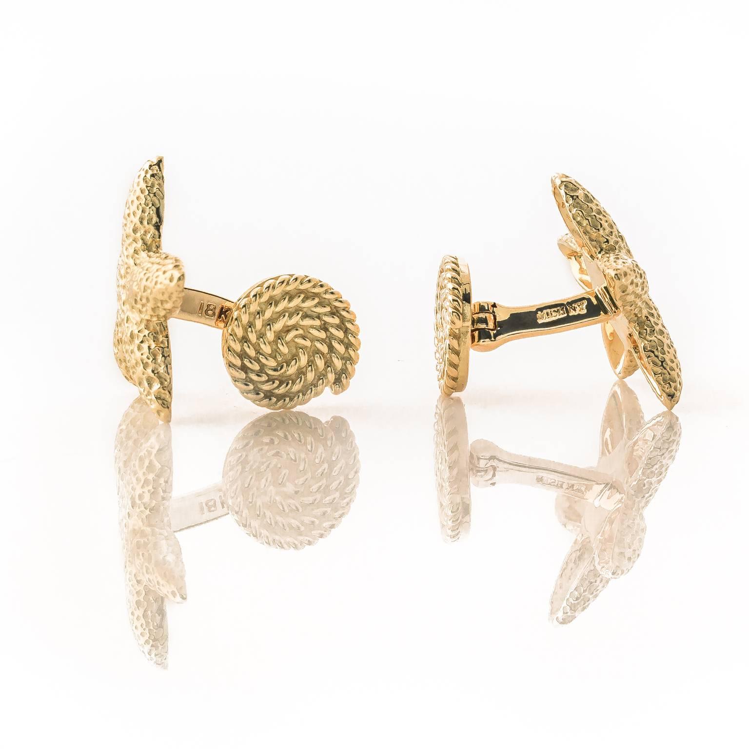 Exquisite pair of 18k yellow gold starfish cufflinks. Feature a textured finish and a nautical rope design toggle.

Stamped MISH NY