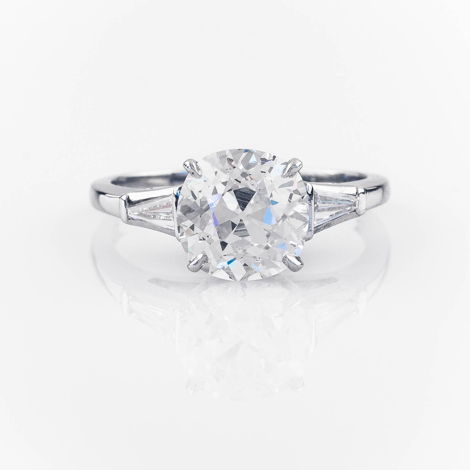 This stunning platinum engagement ring features a beautiful old mine cut diamond is set in a vintage platinum mounting accented with two tapered baguette cut diamonds.

2.51 ctw Old Mine Cut Diamond VS1 - J GIA  Report #5171585884
0.33 cttw