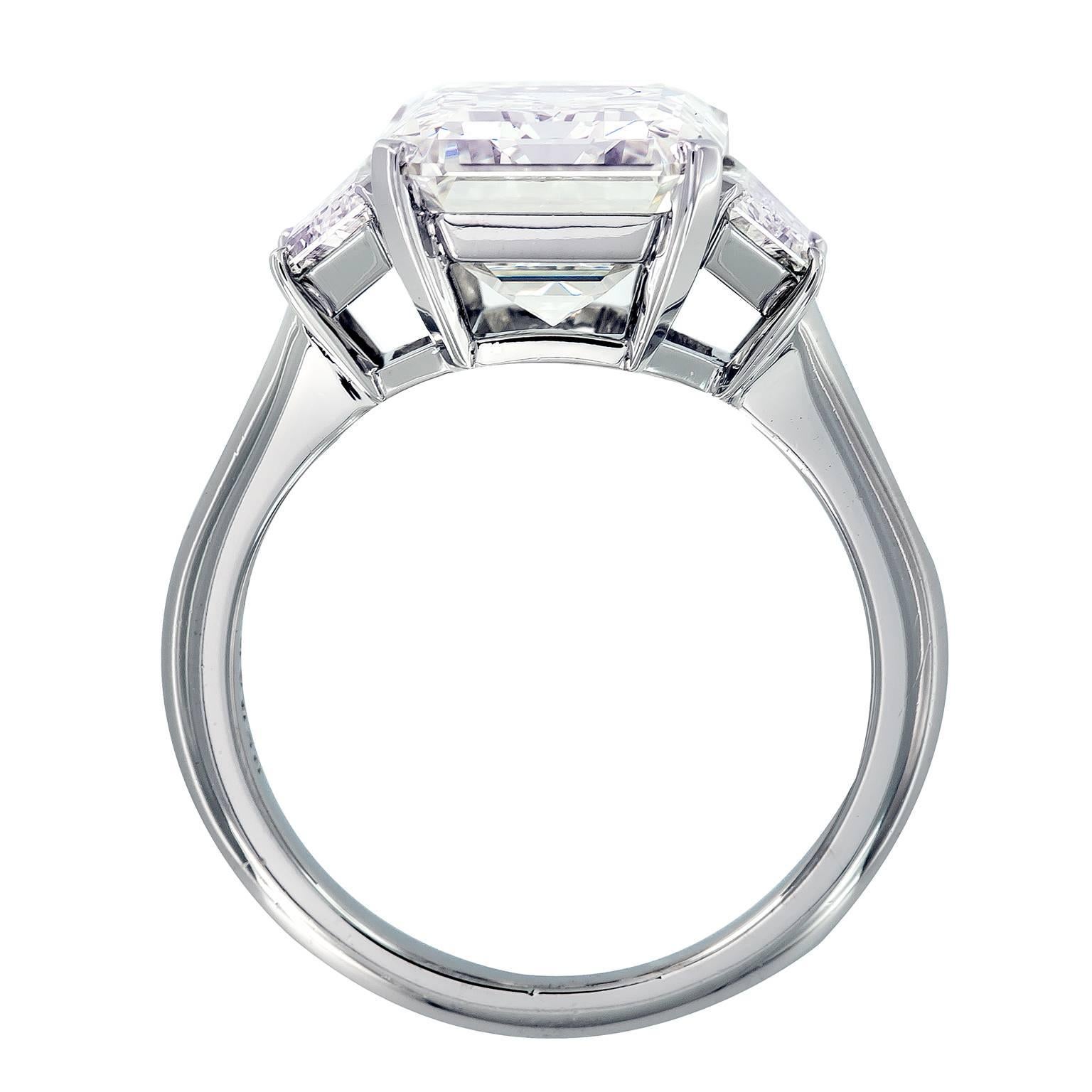 Classic hand-fabricated platinum engagement ring centers around a showstopping 5.51 carat emerald cut diamond accented with two step cut trapezoid diamonds. Ring size 6.25, 11 mm at top, 2.5 mm shank

5.51 Carat Emerald Cut VVS2/J
2 Step Cut