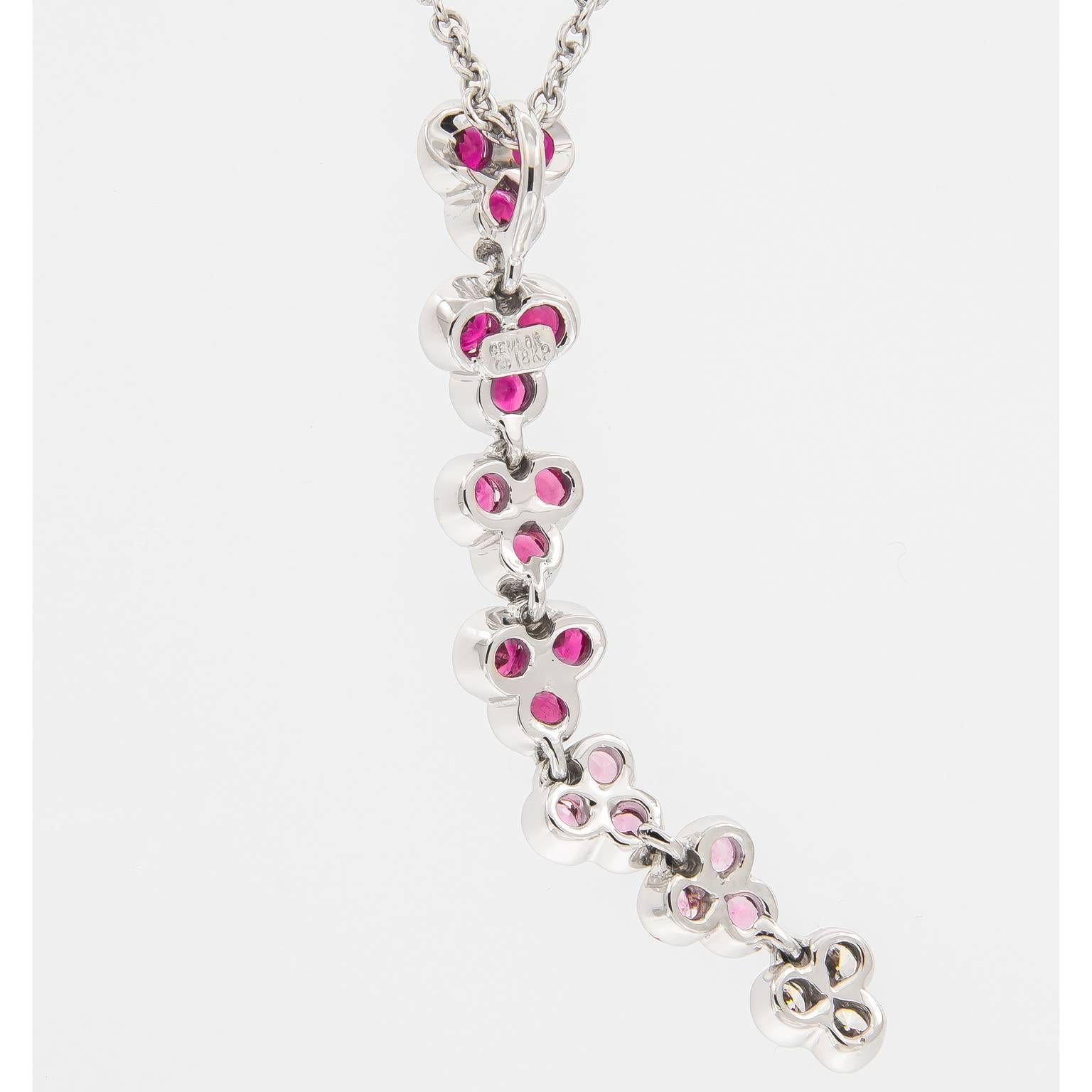 Jean Vitau earrings from the Wisteria Collection are inspired by the vibrant beauty of nature. This lovely 18k white gold, pink sapphire and diamond drop necklace is a beautiful display of color and movement. The seven, three petal design is 1.7 in