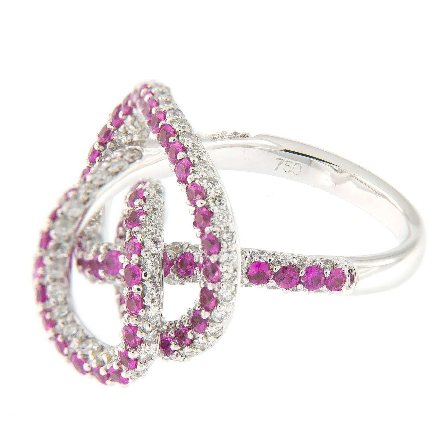 Whimsical 18k white gold large swirl knot ring from Hammerman of New York is compromised of 161 round diamonds and 69 pink sapphires.
Ring Size is 6.25

RBC Diamonds 1.51 cttw
Pink Sapphire 1.62 cttw