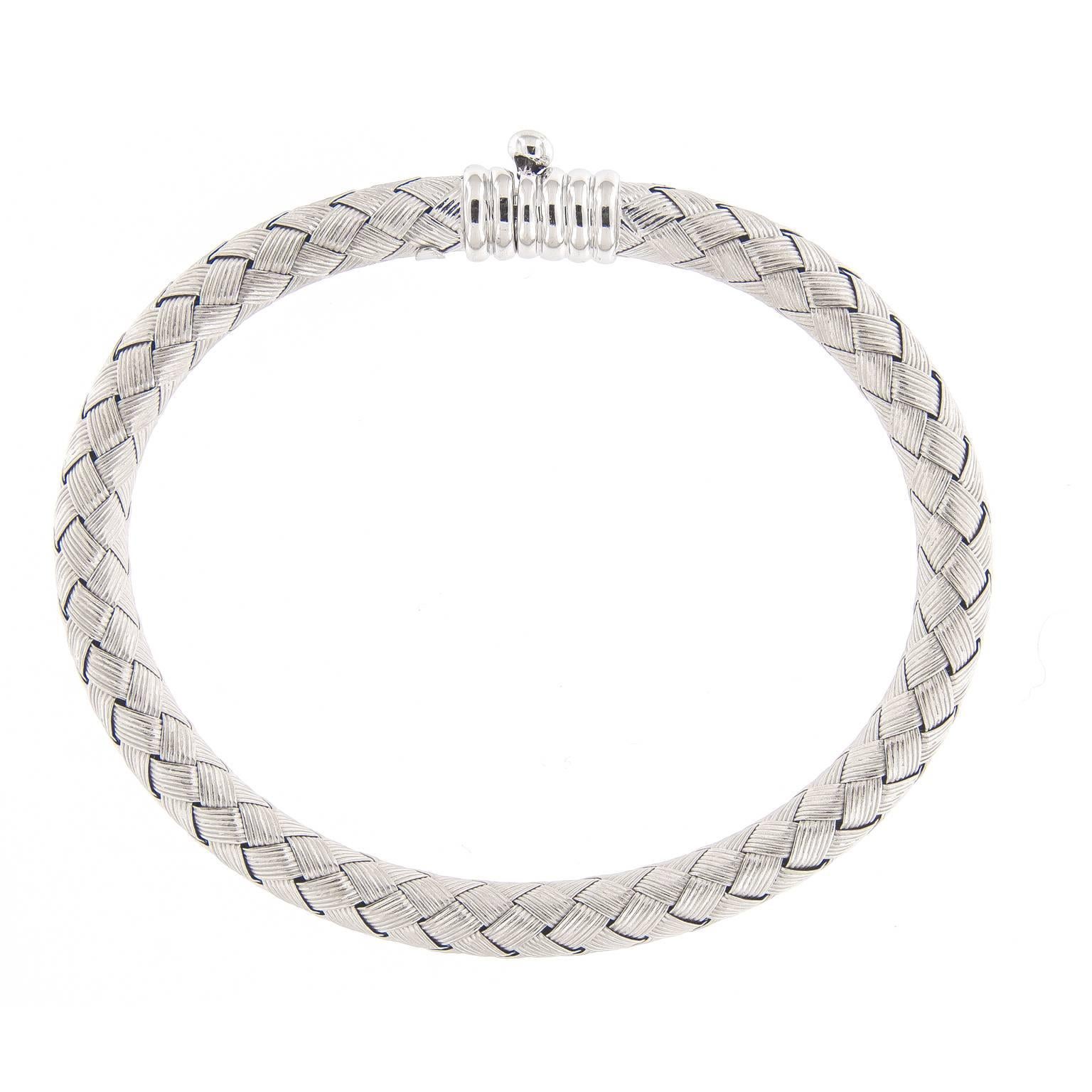 This beautiful Italian bracelet is done with woven
textured sheets of 18k white gold. The finish is a soft
bangle with a smooth feel on the skin. Features a
safety clasp that keeps this piece nice and secure.

Weighs 17.1 grams.
2 in ( 5.08