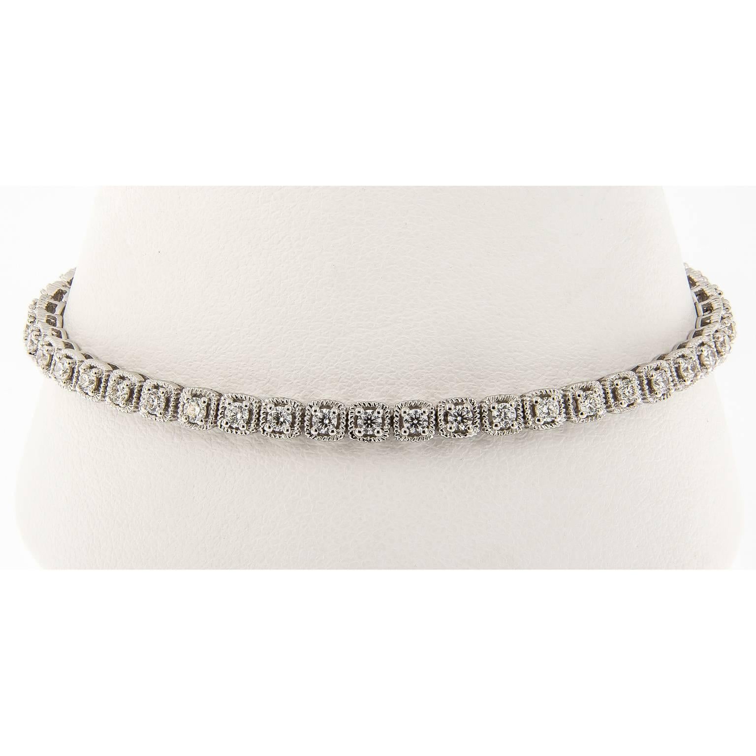 This on-trend design brings a contemporary twist to the classic tennis bracelet. Bracelet is executed in 18k white gold and has a unique link design, accented with prong set diamonds. She can wear one, two or more bolo designs together to create a