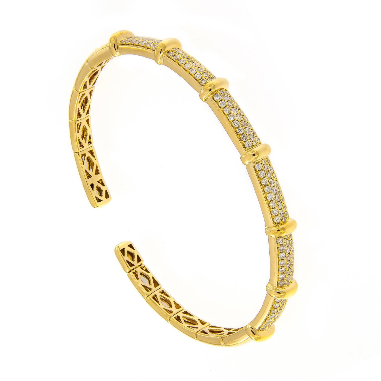 Three rows of round brilliant cut diamonds separated by gold bar stations are beautifully crafted in 18k yellow gold. Striking on it’s own or stack two or more to create a bolder look. Bracelet is flexible. Inner diameter 2 in w 2.25 in. 6 mm