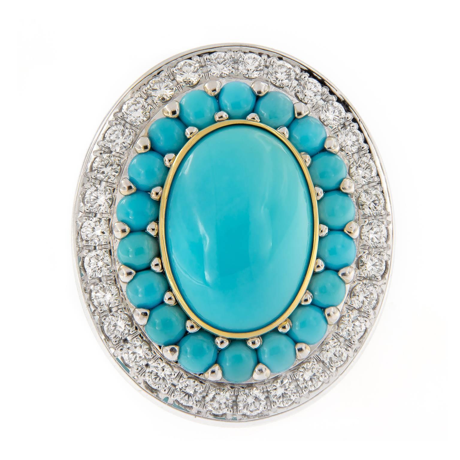 Outstanding display of color and Italian craftsmanship. This ring centers around an oval turquoise accented with smaller turquoise and diamonds. Center stone is 18 mm x 12 mm and is set in a gold ring. Ring is constructed of 18k yellow gold with a