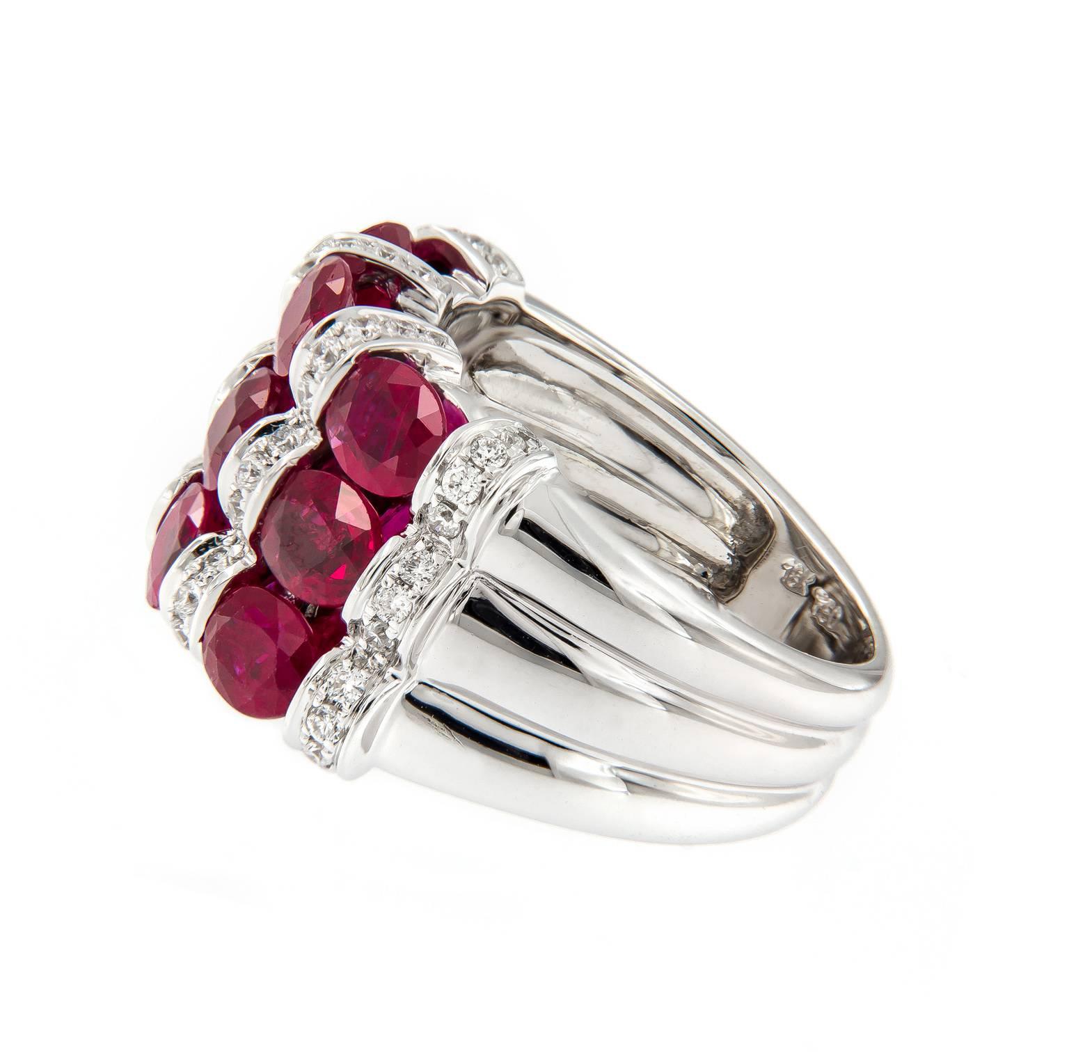 Alternate rows of contrasting mixture of oval rubies and pave set diamonds create a stunning look. This beautiful statement ring is crafted in 18k white gold.
Ring size 6.75. 13 mm wide.

Rubies 3.95 cttw
Diamonds 0.40 cttw