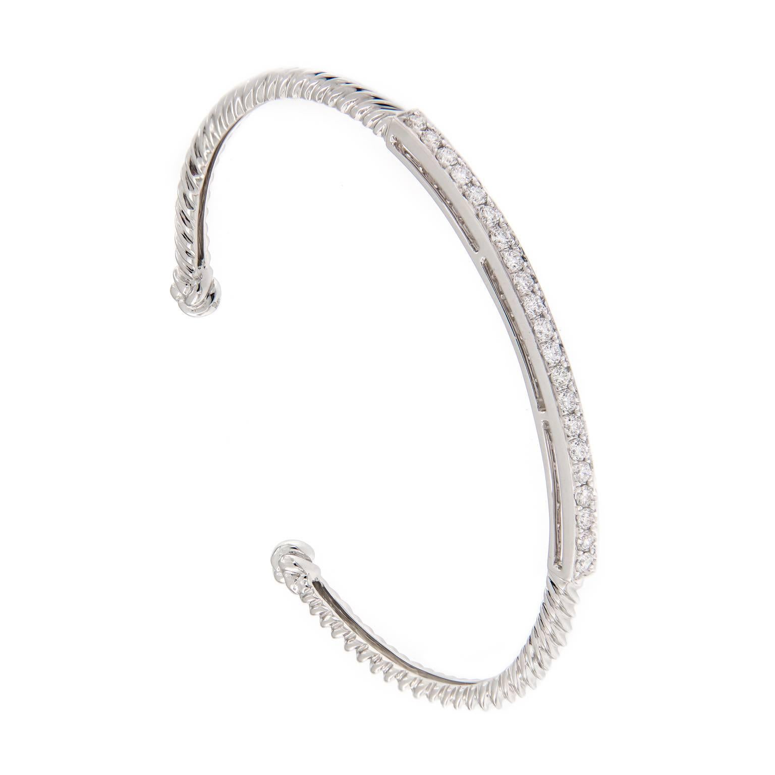 Classic cable design is expertly crafted in 18k white gold and nicely accented with 21 round brilliant cut diamonds. Striking on it’s own or stack two or more to create a bolder look. Weighs 11.5 grams.
Inner diameter 2.375 in x 1.75 in.  3.5 mm