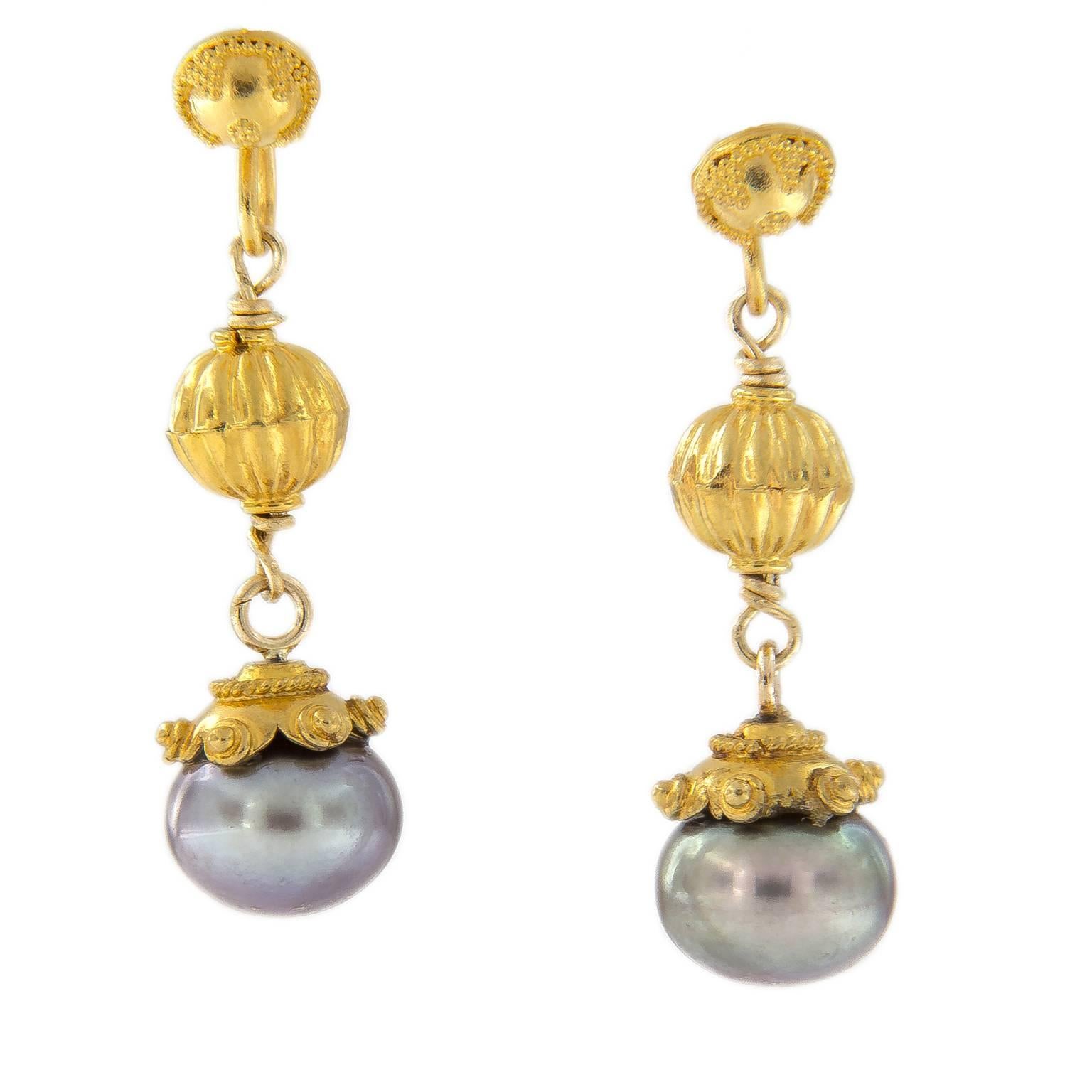 You’ll love the lustrous look of these freshwater cultured pearls. But what makes these pearls eye-catching is the ever changing shimmer of hints of green, blue, and gray with lovely detailed beads and caps. Earrings are hand-crafted in 22k and 18k