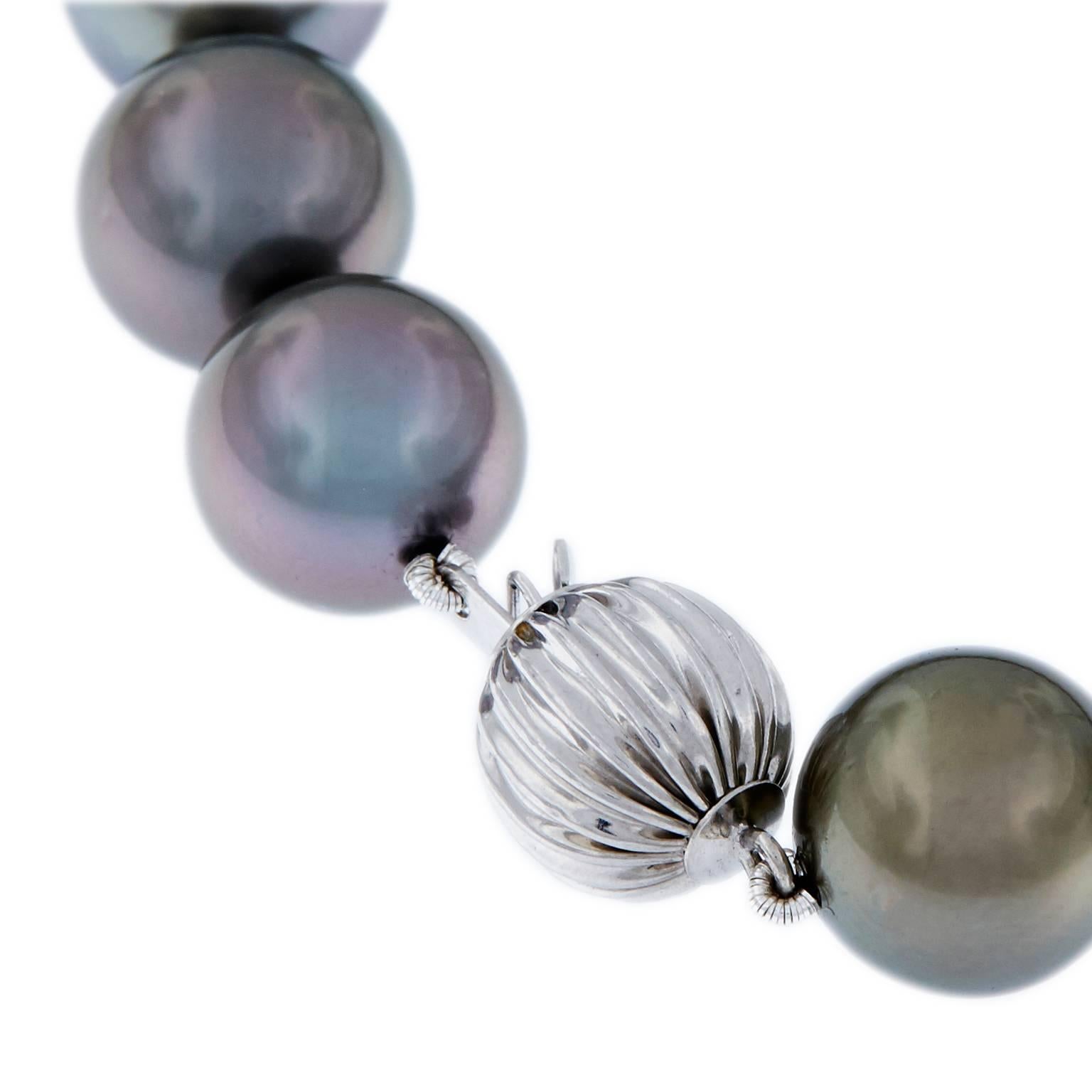 Outstanding Tahitian pearls featuring radiant luster and overtones. Necklace comprised of 35 large 11-14.8 mm pearls. Clasp is 14k white gold. Weighs 87.9 grams. 18 in Long.