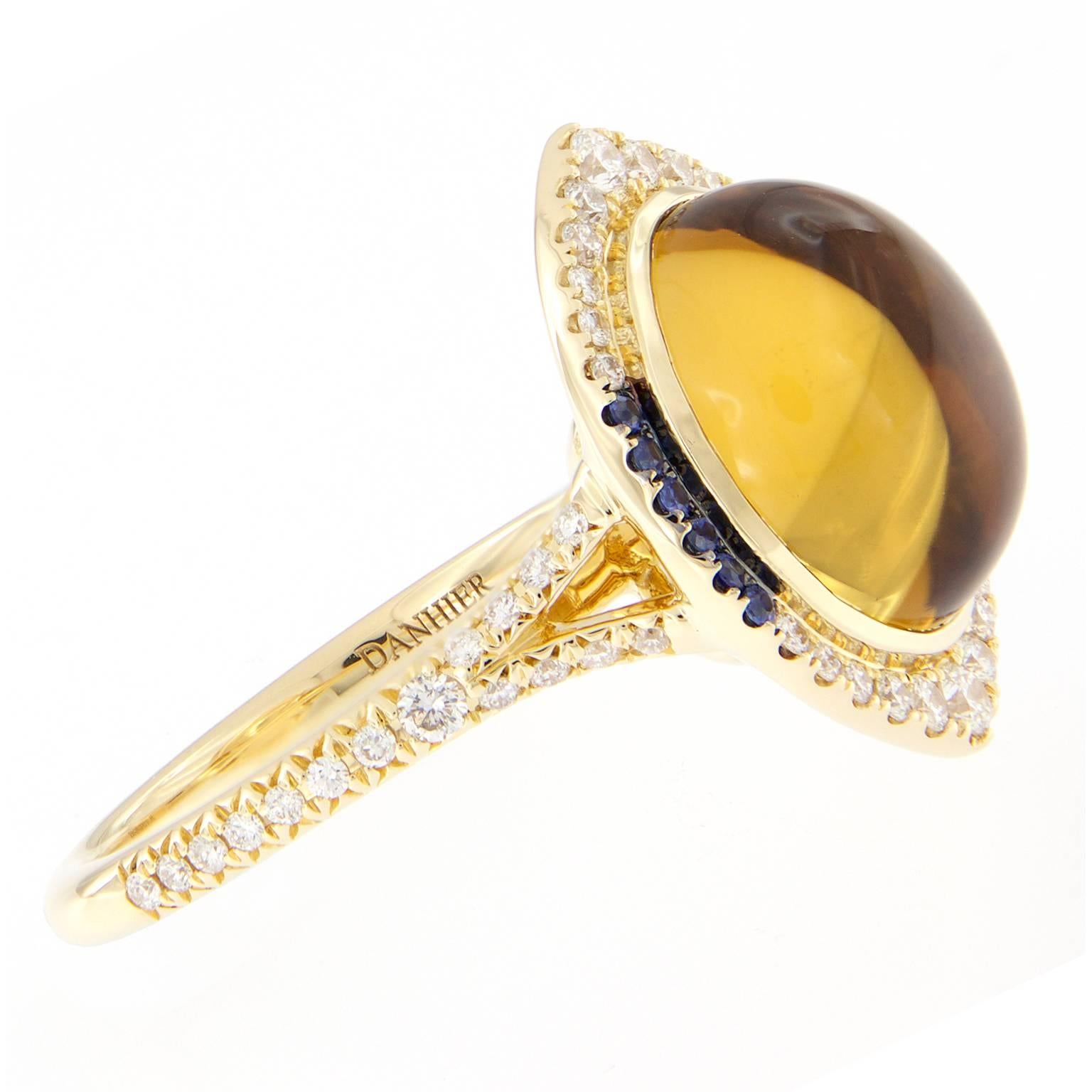 How eye catching is this Danhier creation from the Candide Eye Collection? This beautifully crafted ring centers around an 18 carat citrine accented with a halo design of white diamonds and blue sapphires. 

 Ring size 6.75 ( can be sized)
Citrine