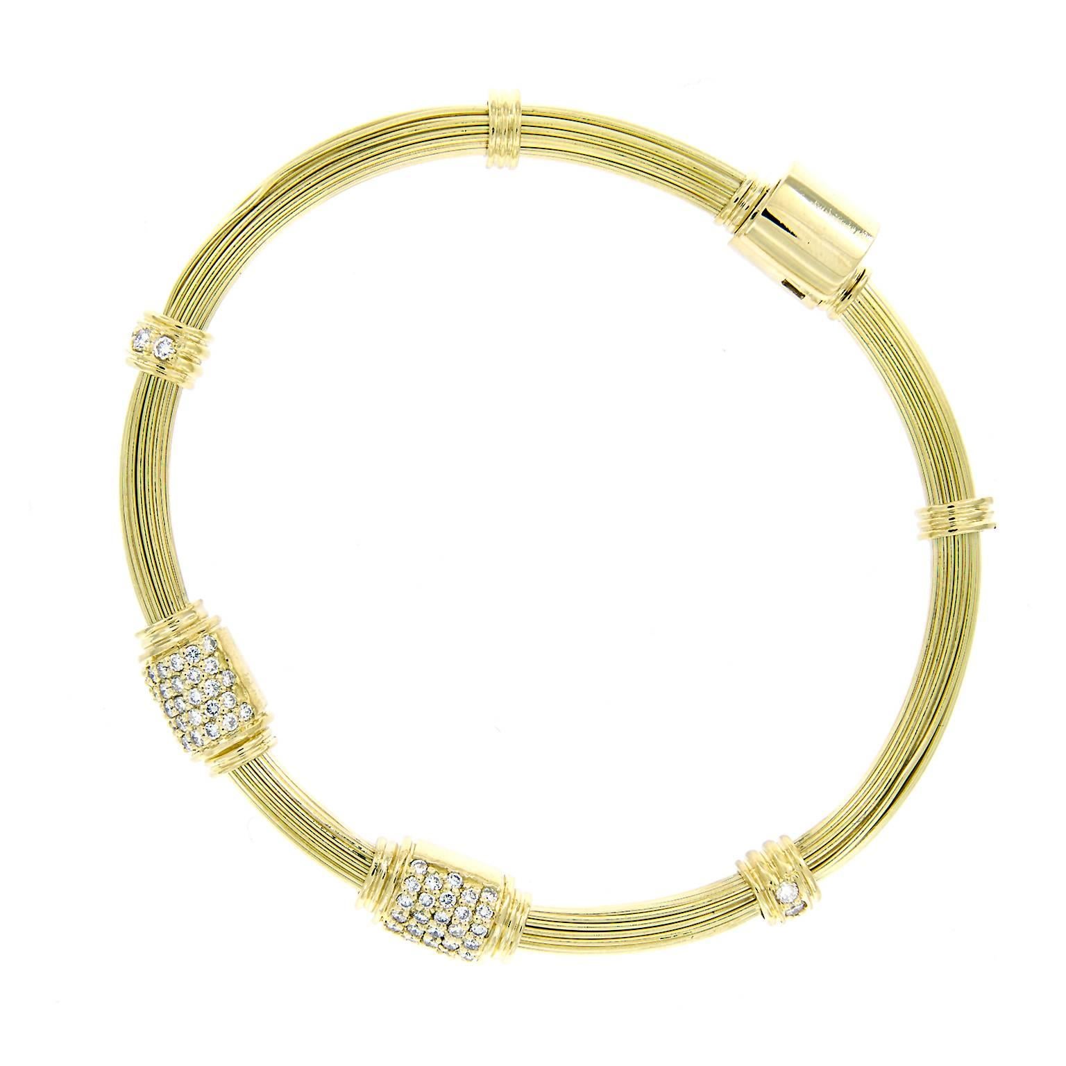 Beautiful 18k yellow gold version of the sought-after iconic elephant hair bangle, worn for good luck. Bracelet features two diamond accented knots. Hodden clasp with clamp over safety 

Inner Diameter 2.25 inches.
Diamonds 0.99 cttw VVS-VS F-G