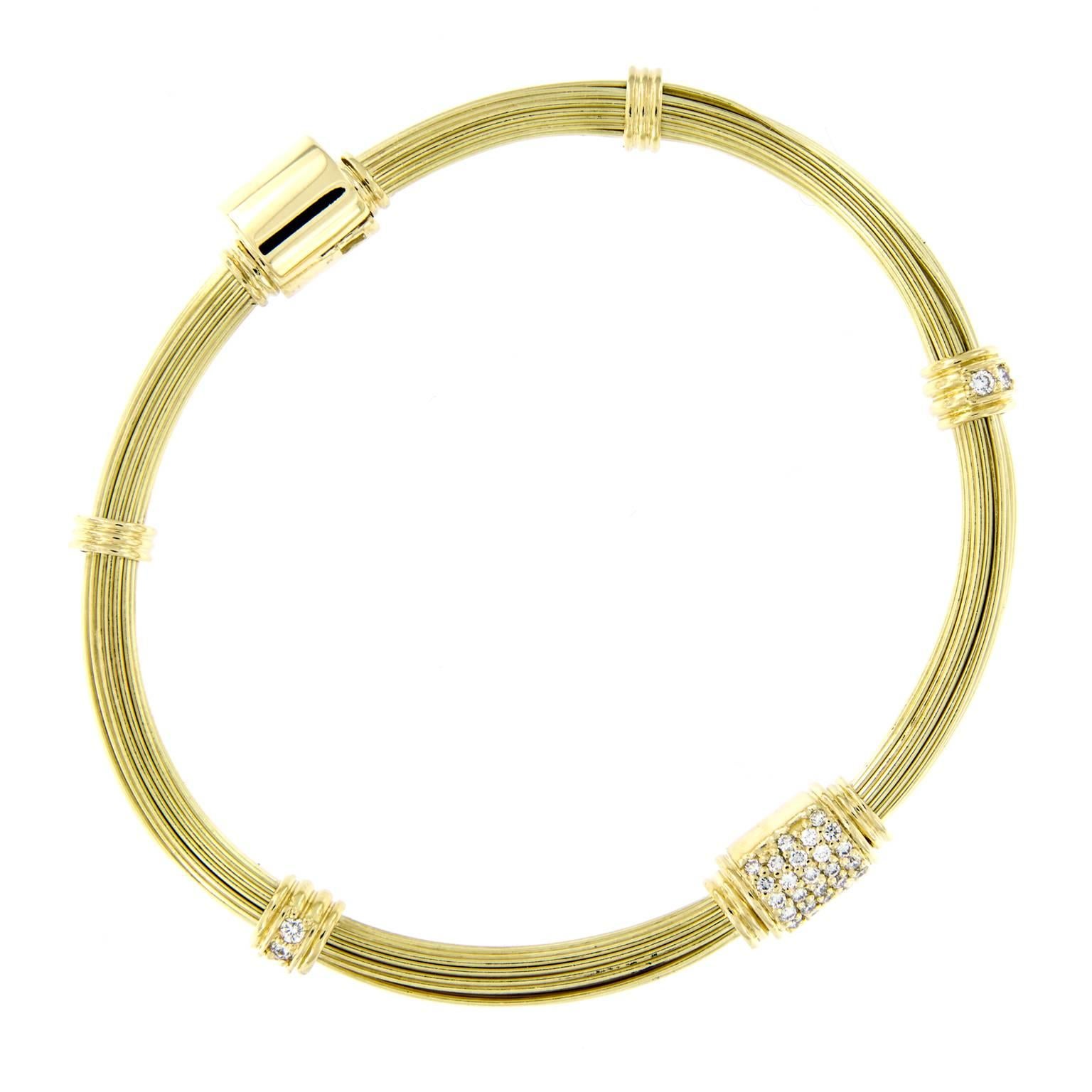 Beautiful 18k yellow gold version of the sought-after iconic elephant hair bangle, worn for good luck. Bracelet features one diamond accented knot & hidden clasp with clamp over safety

Diamonds 0.59 Cttw VVS-VS F-G
 2.25 in. inner diameter