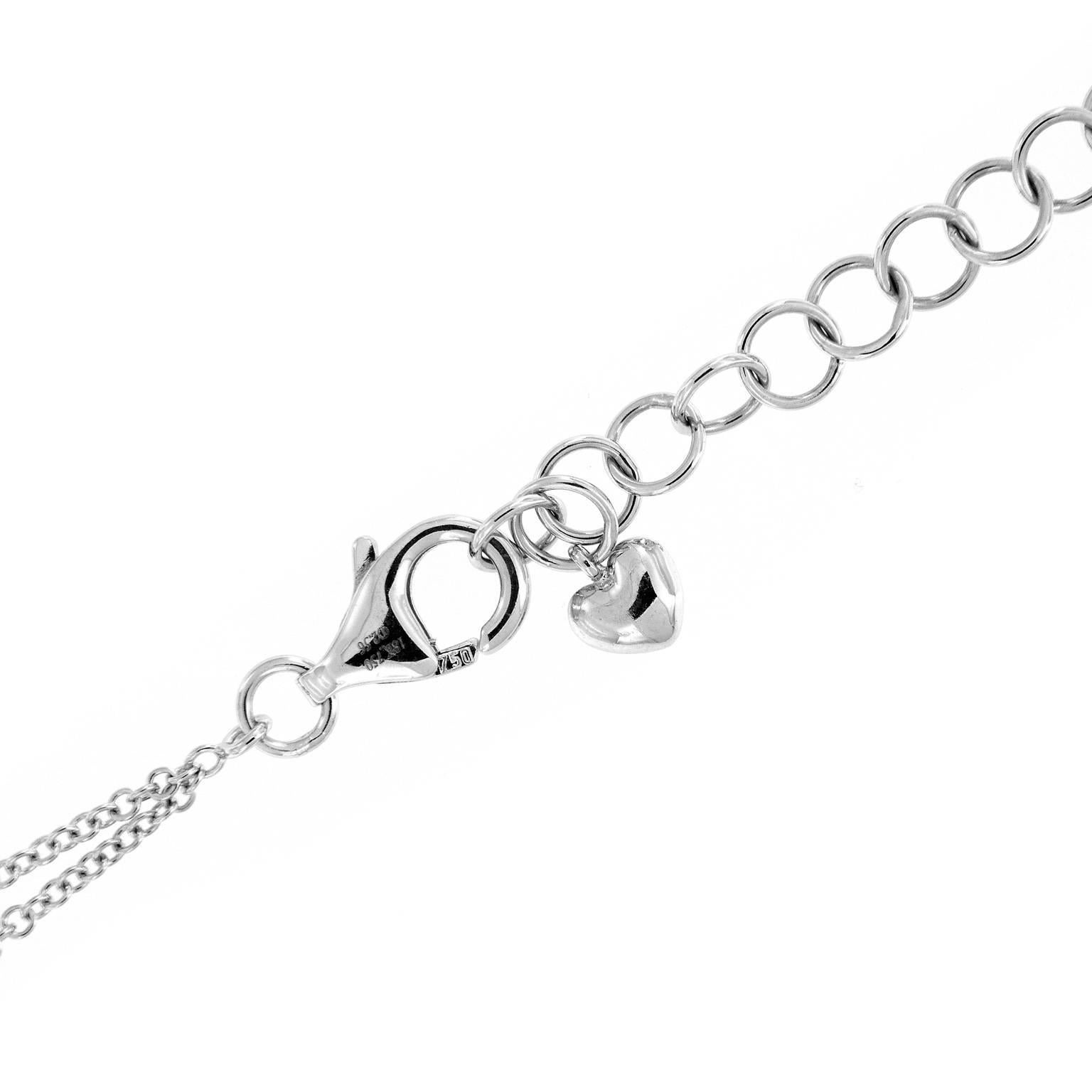 This stunning pendulum statement necklace features a pave set diamond teardop, that hangs from a diamond cluster and a nine diamond drop link. The double cable link chain is 18k white gold with a little puff heart dangle at clasp. Diamond tear drop