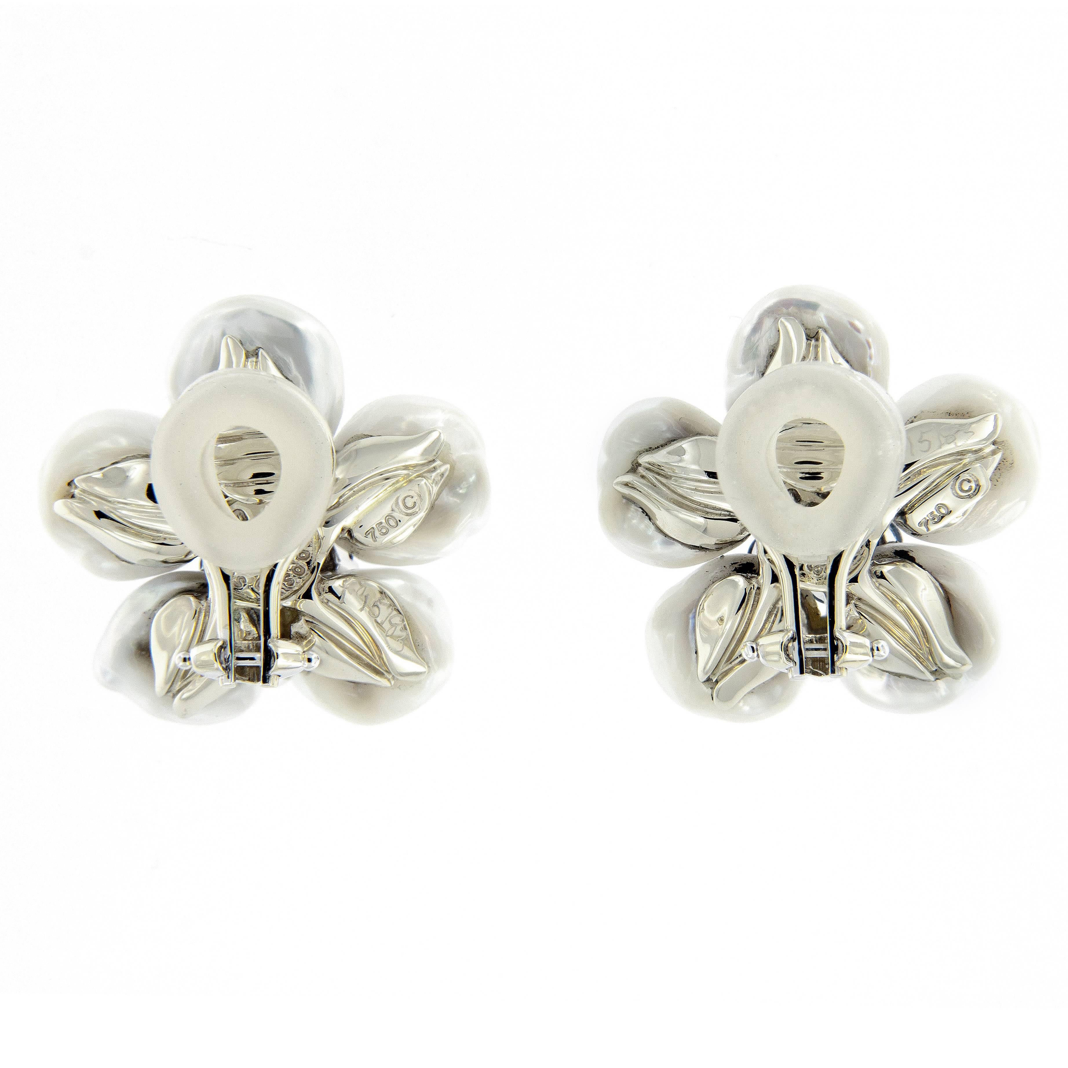 Earrings with freshwater pearl petals and blue sapphire cluster centers create the “Biwa Flower” design. Earrings are 18k white gold with clip backs. Designed by Seaman Schepps. Weigh 12.8 grams.

Sapphire 1.30 cttw