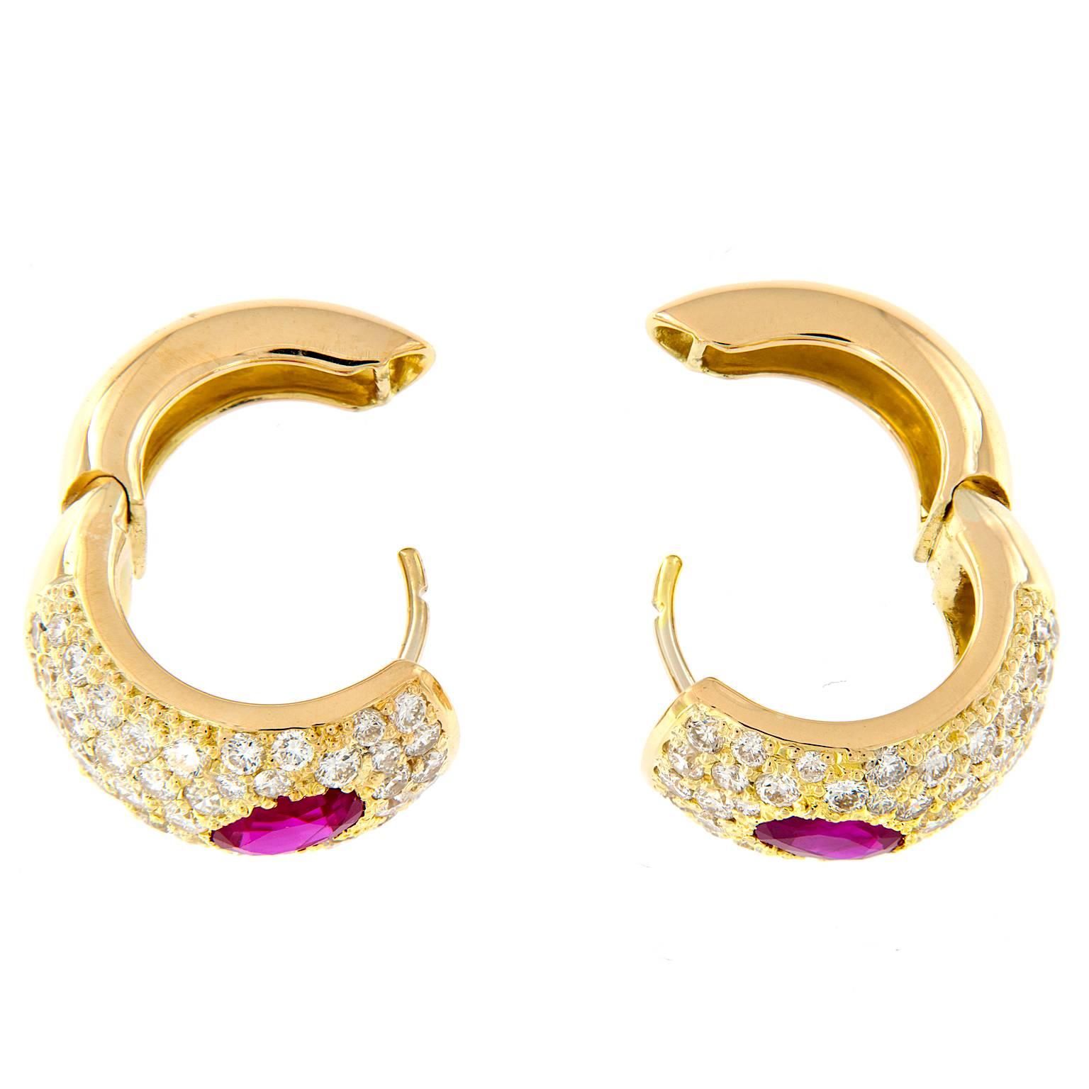 Stunning huggie earrings crafted in luxurious 18k yellow gold. Five staggered rows of diamonds accent a singular oval ruby in each earring. Weighs 13.3 grams

Diamonds 2.63 cttw
Ruby 2.14 cttw
Marked Italy