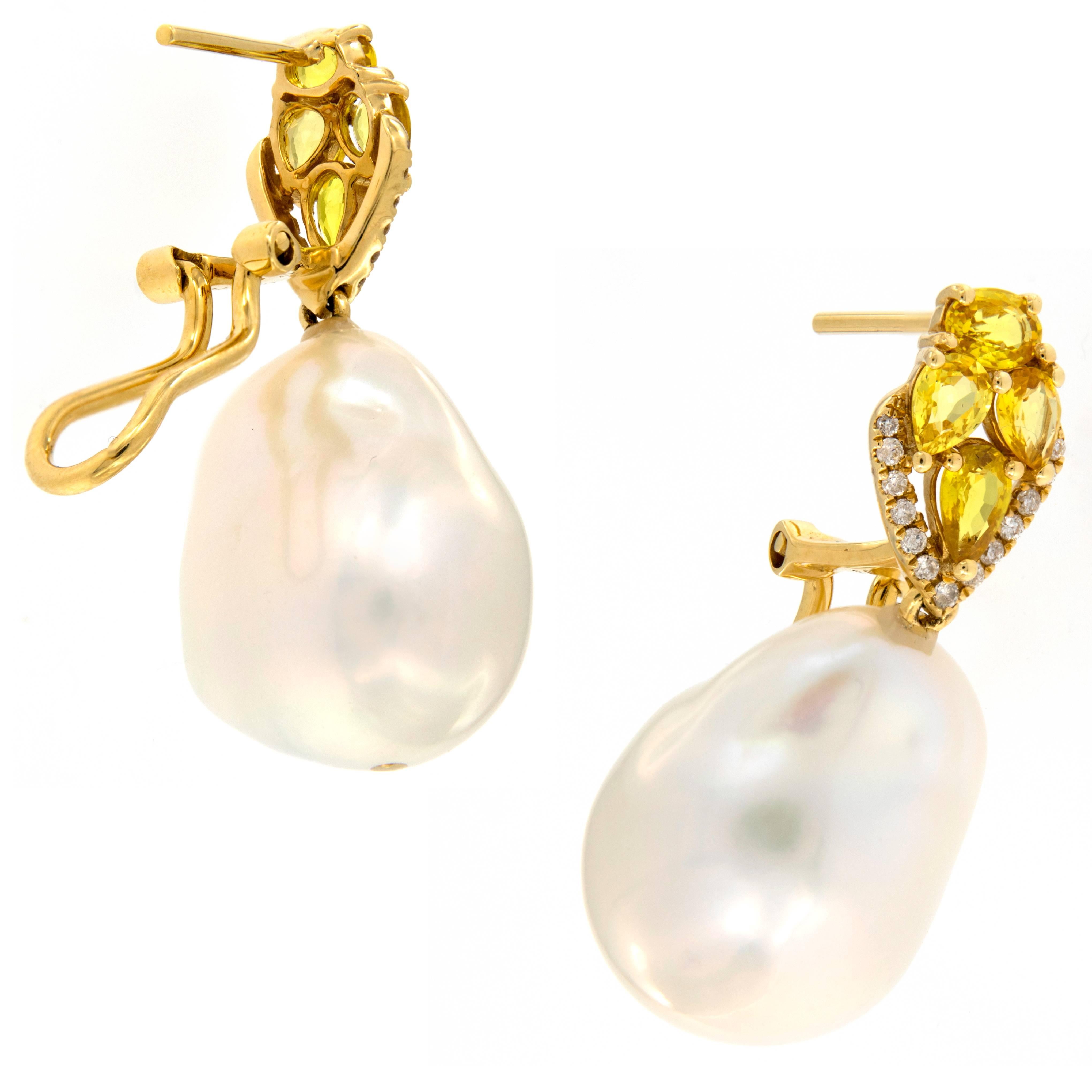 Lovely baroque pearl drop earrings crafted in 18k yellow gold drop from yellow sapphire clusters  accented with a row of diamonds. Omega clip backs. Weigh 13.4 grams.
Sapphires 1.70 cttw
Diamonds 0.17 cttw.