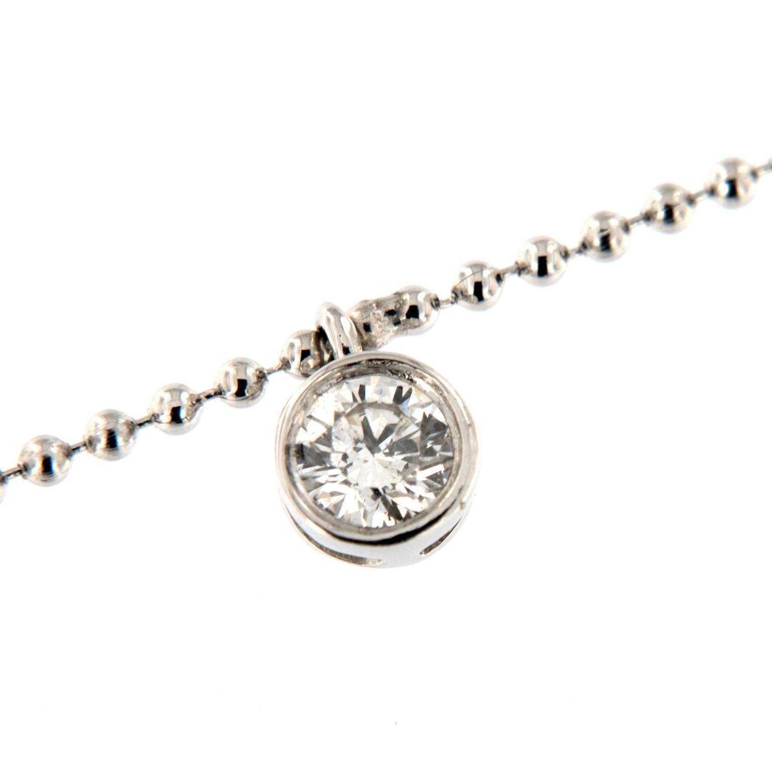 This 14k white gold necklace provides a touch of sparkle and sway for every day.  Seven Bezel-set round brilliant-cut diamonds dangle from an adjustable 16 inch beaded chain with a lobster clasp. Weighs 3.3 grams. Necklace can be worn as a choker or