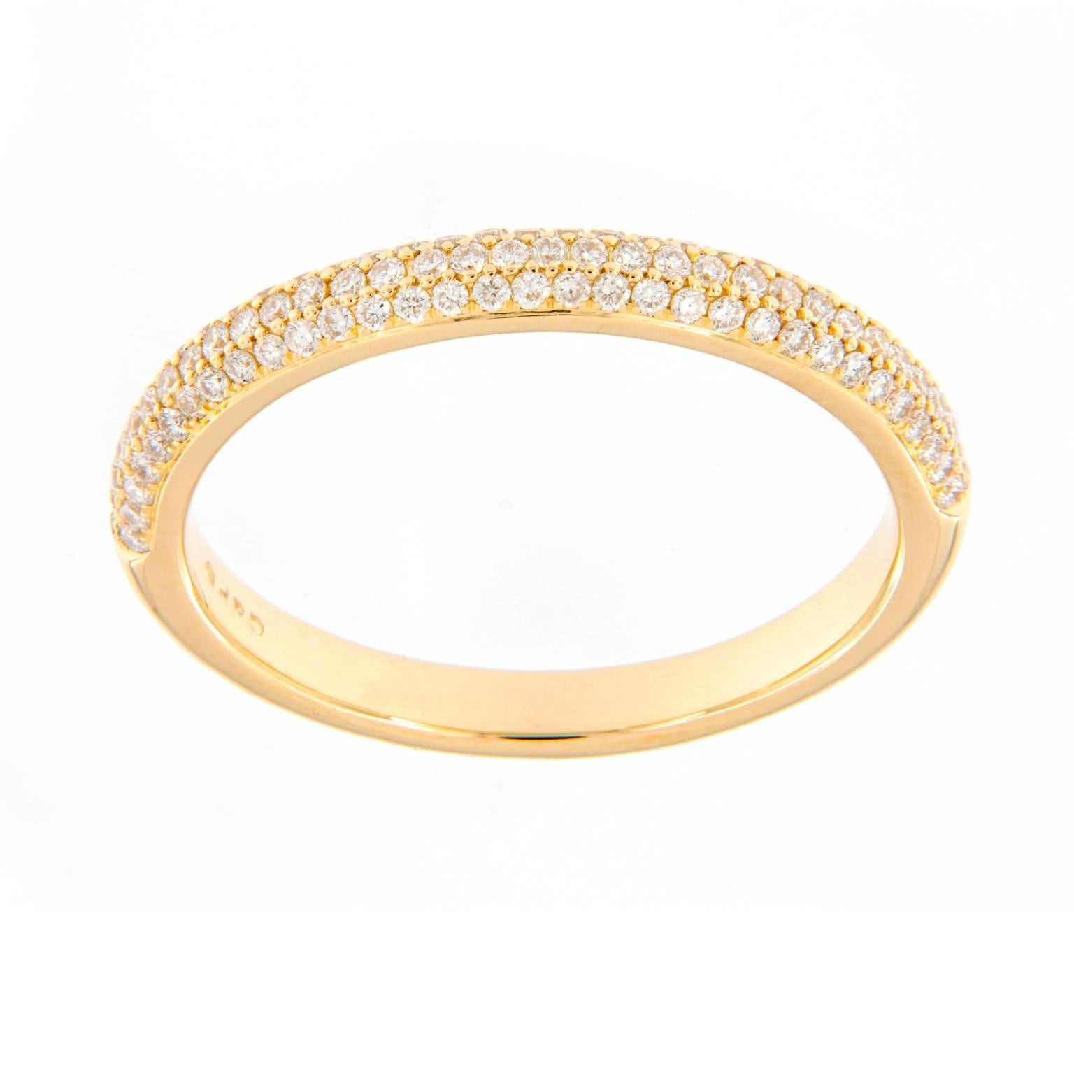 This delicately crafted 18k yelllow gold wedding anniversary band ring features three rows of micropavé set diamonds that weigh a total of 0.58 cttw. Ring size 7. Weighs 3.3 grams.

Diamond 0.58 cttw