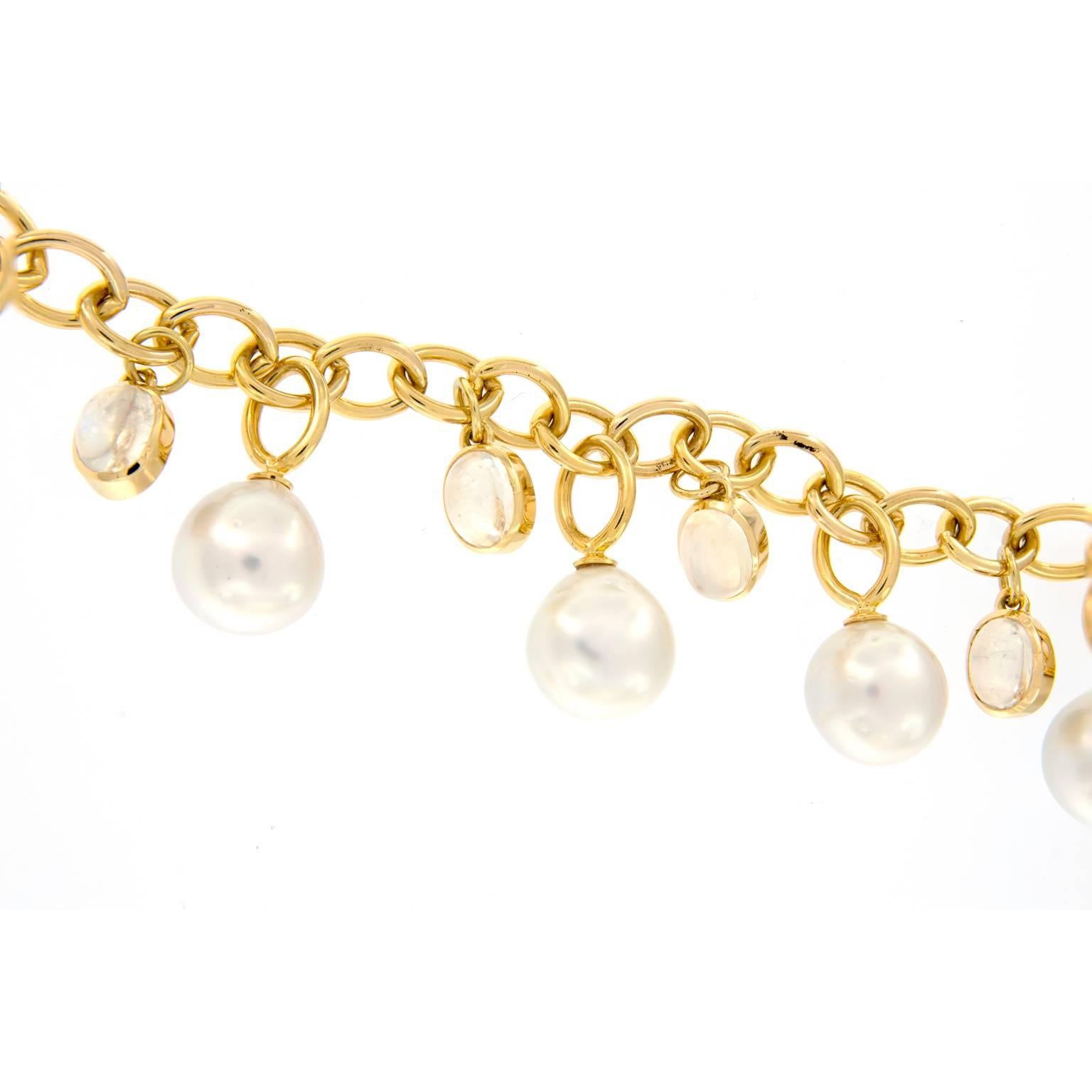 Beautiful baroque pearls and moonstones dangle from this 18k yellow gold link style charm bracelet from Assael.
Weighs 41.4 grams.

Moonstone 17.13 cttw ct
