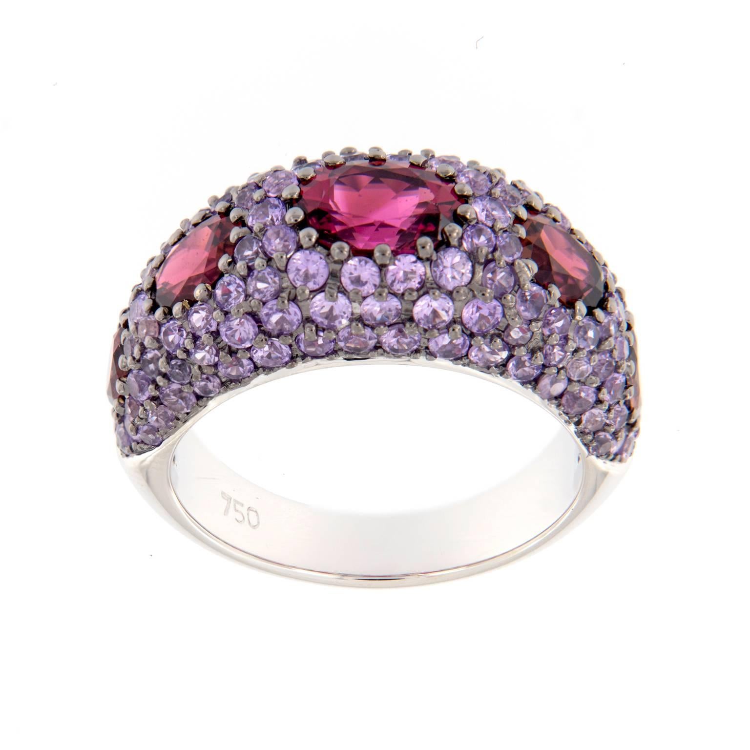 Beautiful combination of violet sapphires and pink tourmalines create a unique look. Dome ring is crafted in 18k white gold. Ring size 6.75. Weighs 9 grams

Sapphire 2.81 cttw
Tourmaline 2.27 cttw