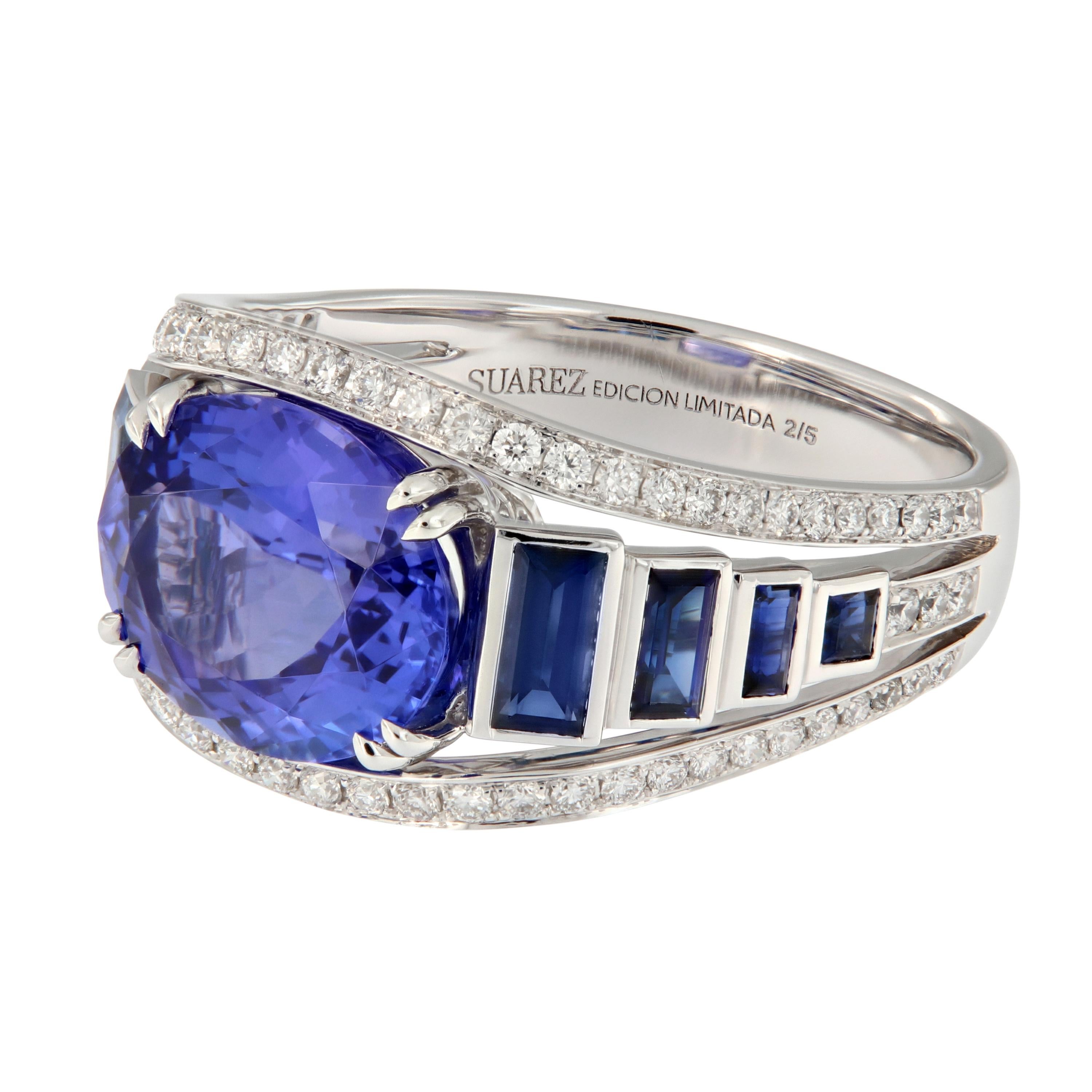 Expertly crafted in 18k white gold, this ring features an oval blue tanzanite center and blue sapphire edging accented with diamonds. This beautiful ring is from the Géométrie Collection by Suarez of Spain. Weighs 7.2 grams. Ring size 6.25.
Marked